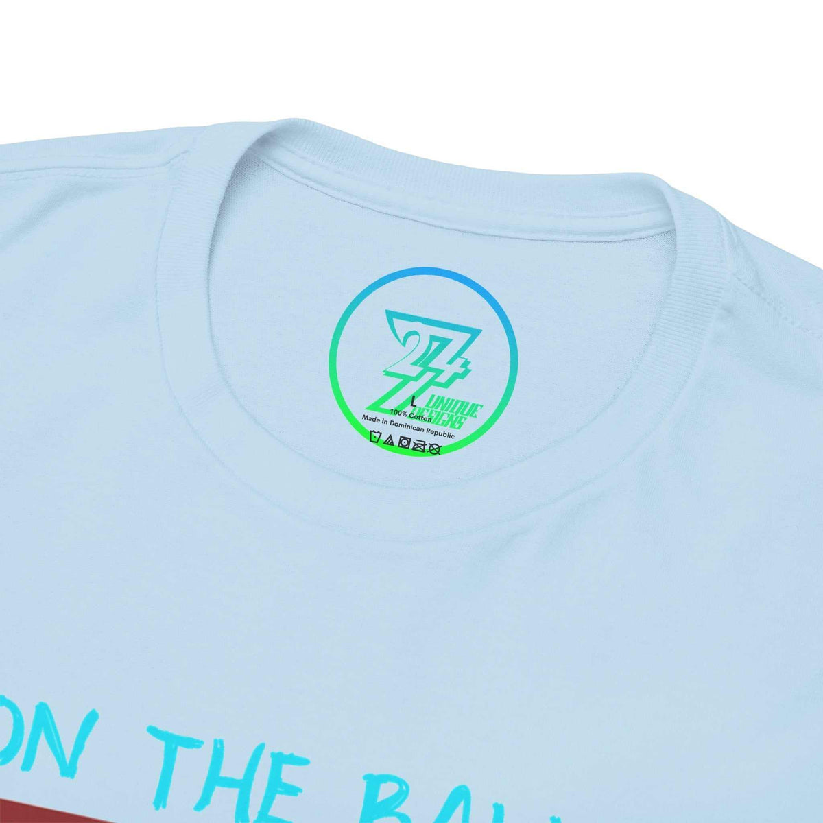 Close-up of the ribbed knit collar on the light blue racket sports apparel tee, clearly showing the official 24/7 Unique Designs trademark logo inner label branding.
