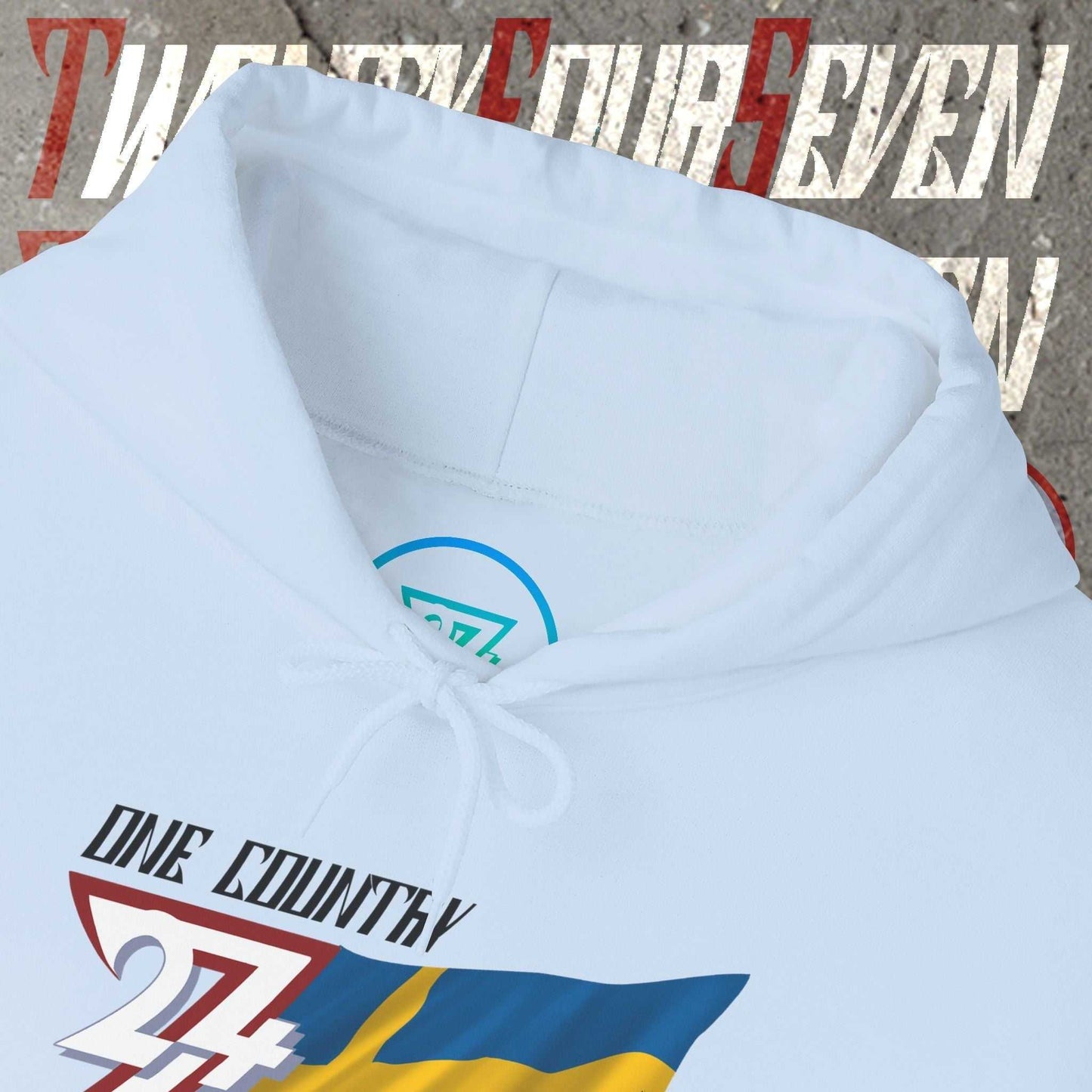 Macro close-up of the inner neck area showing the tear-away label and authentic 24/7 Unique Designs trademark logo.