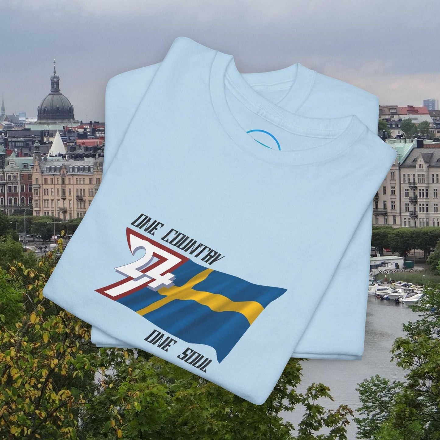 Light blue Sweden flag graphic tee with hand-drawn Swedish flag and "One Country One Soul" text, unisex crewneck shirt.