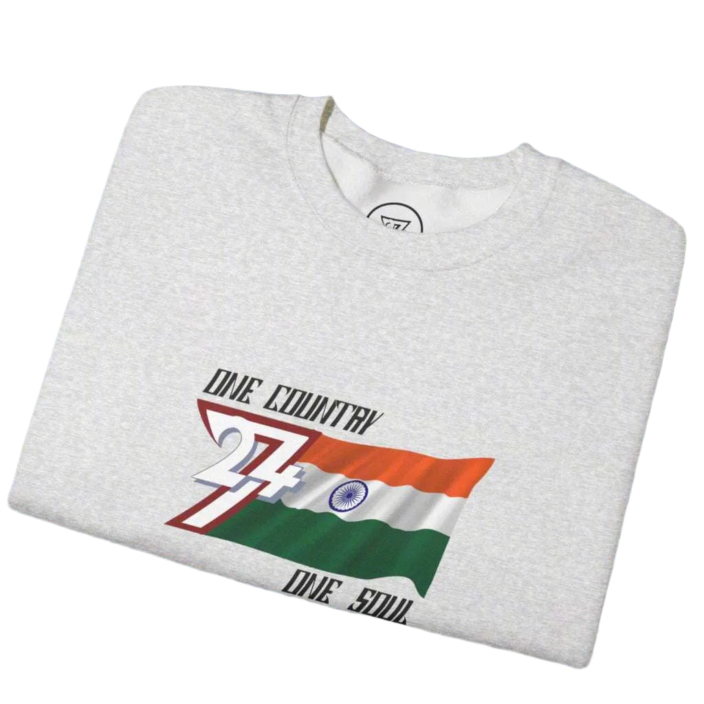 Folded light gray sweatshirt with India flag design and "One country one soul" slogan on chest against blue sky background