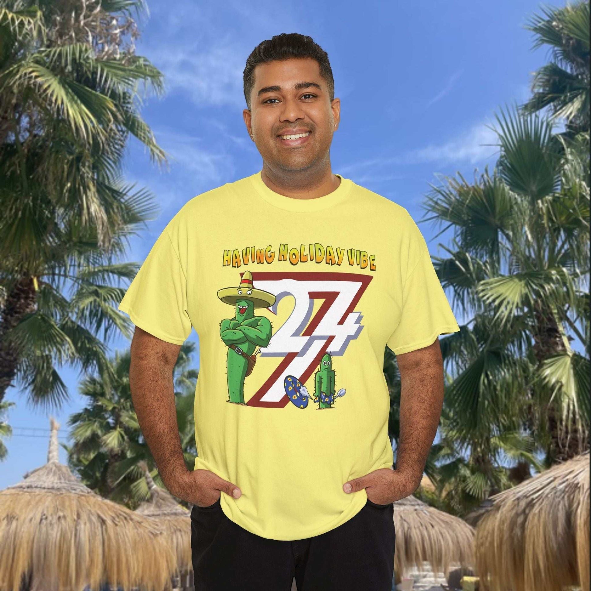 Man wearing a light yellow humorous graphic tee displaying the Having Holiday Vibe cactus design.