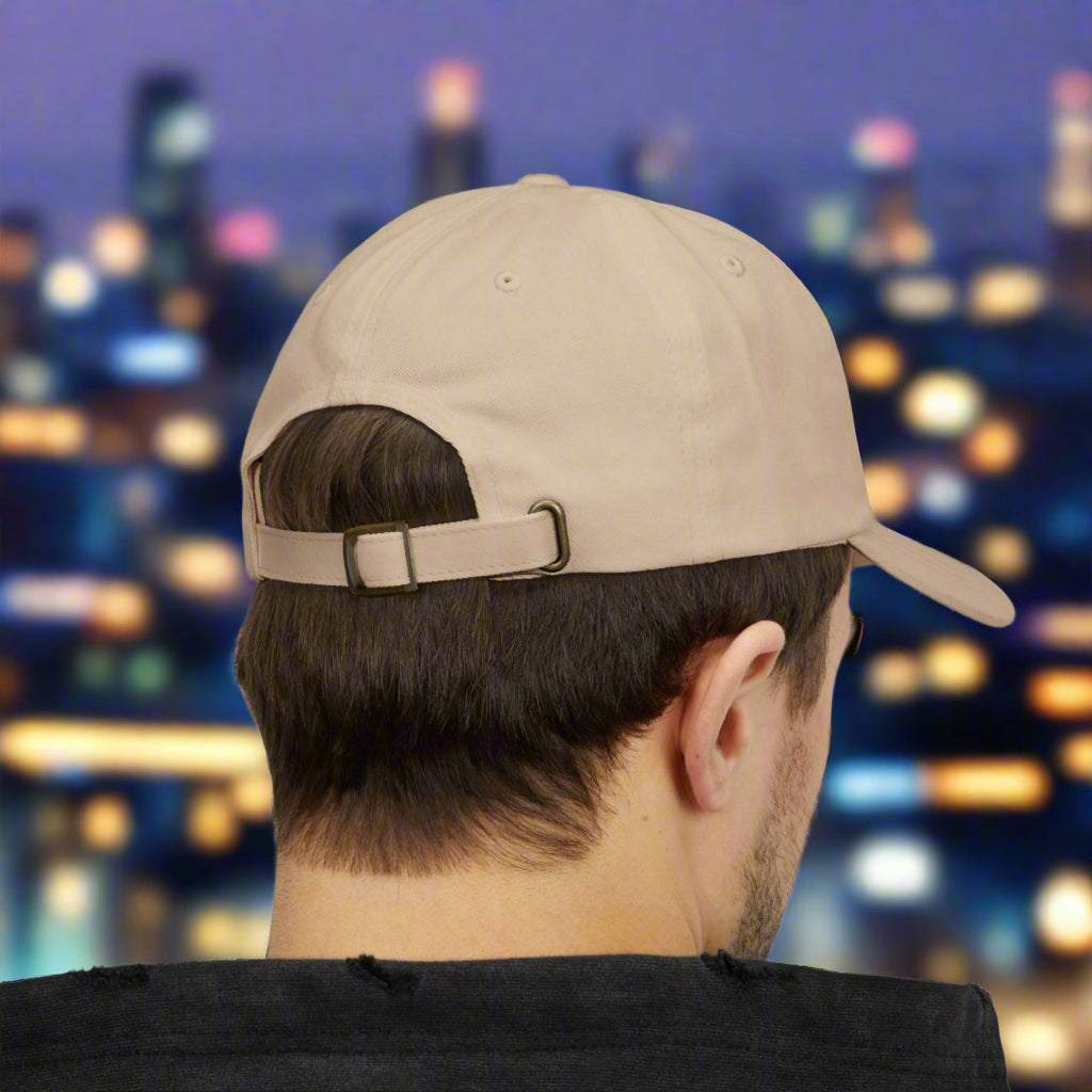 Male model seen from behind wearing the stone colored smooth fabric baseball hat.