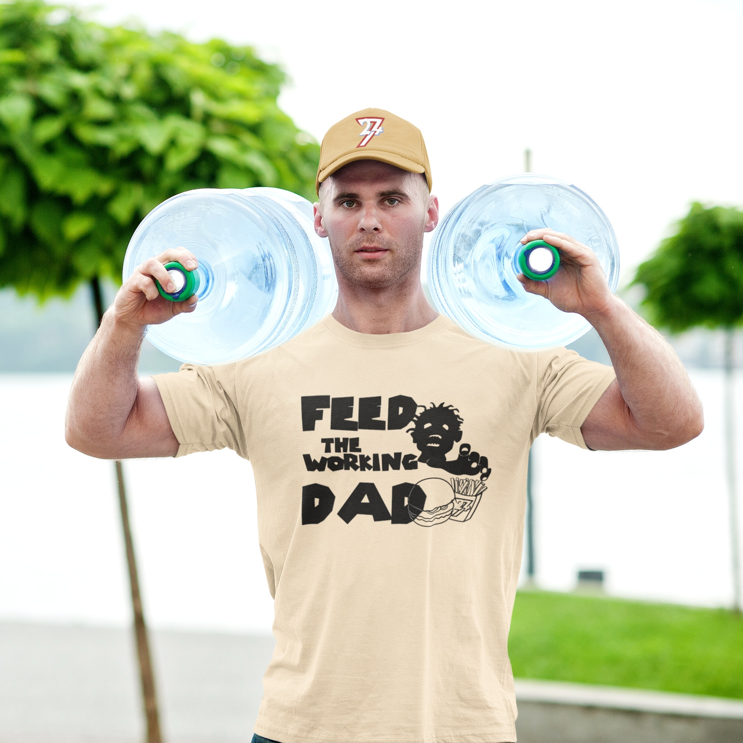 Male model showcasing the heavy cotton drape of the beige working dad zombie t-shirt.