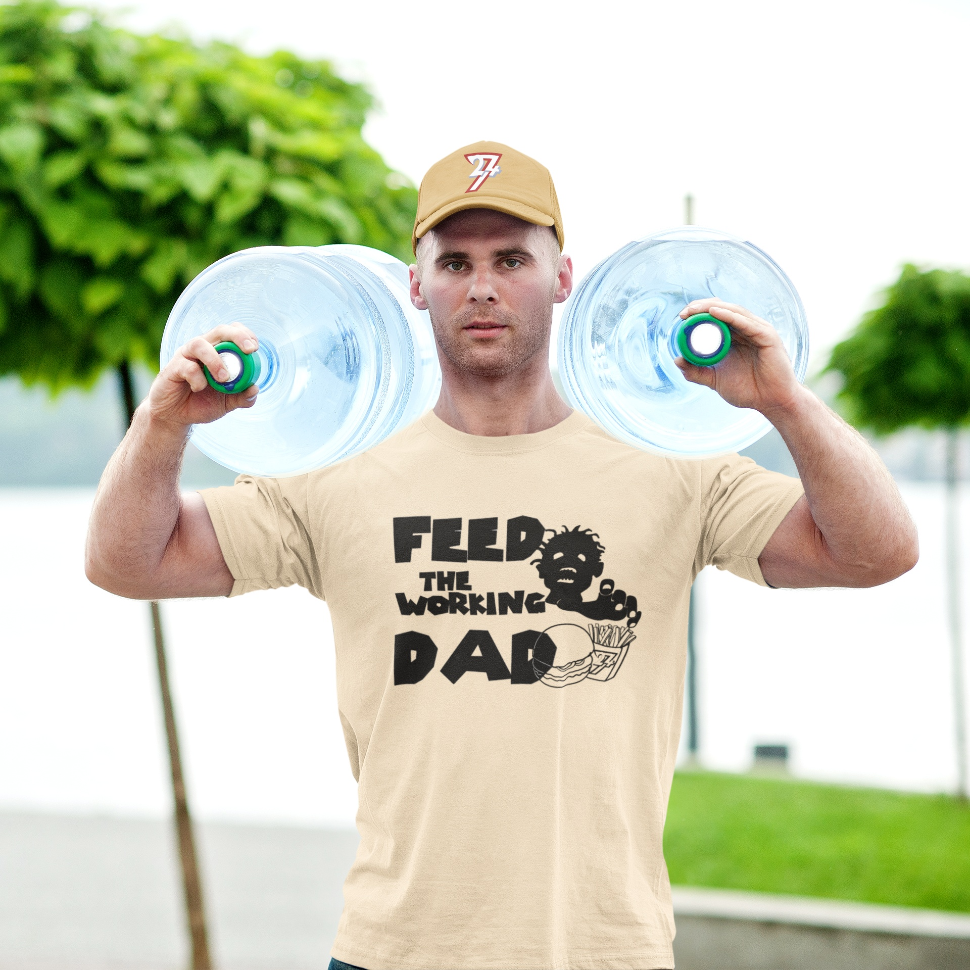 Male model showcasing the heavy cotton drape of the beige working dad zombie t-shirt.