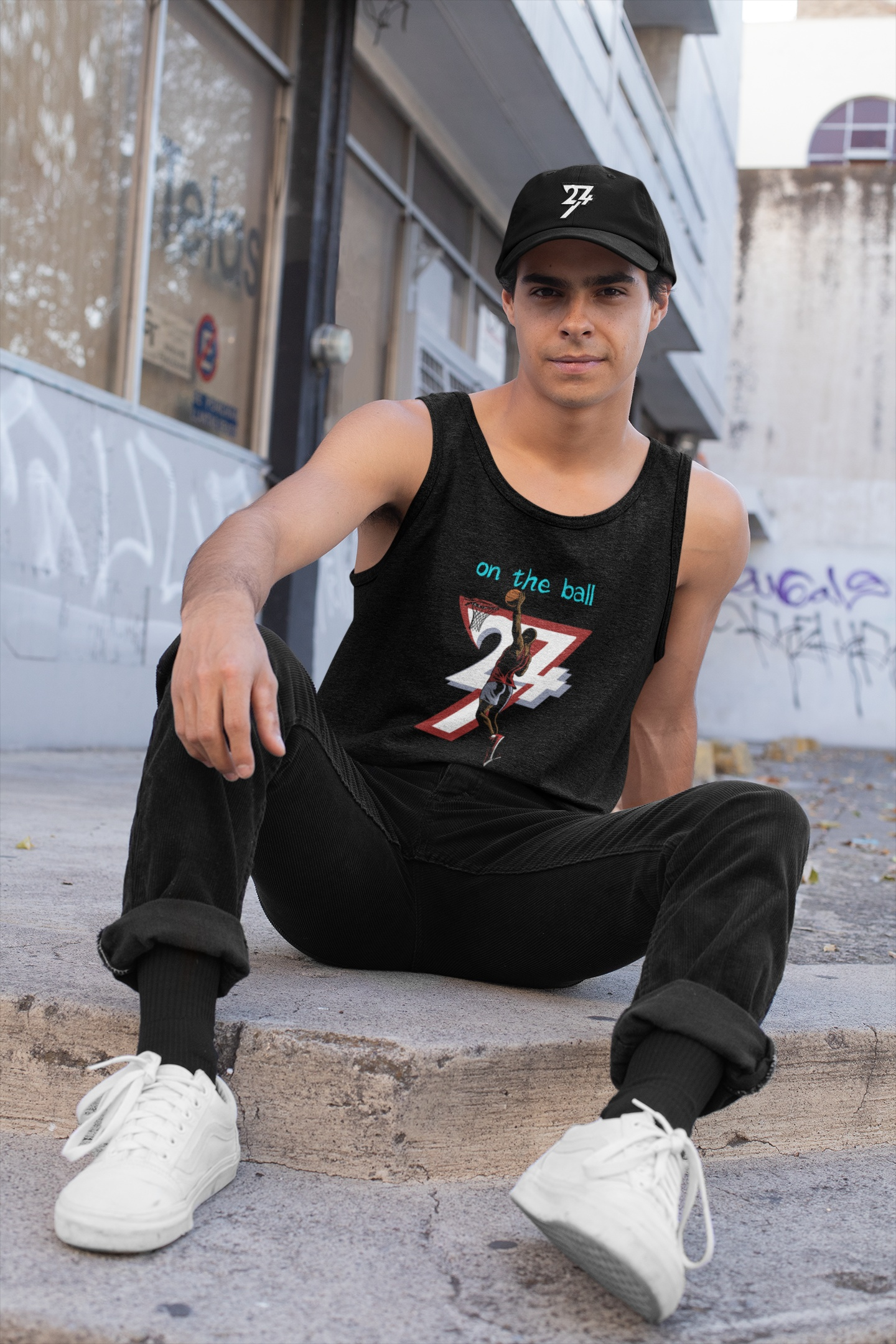 Model wearing the black basketball tank and the 24/7 Logo Baseball Cap in black