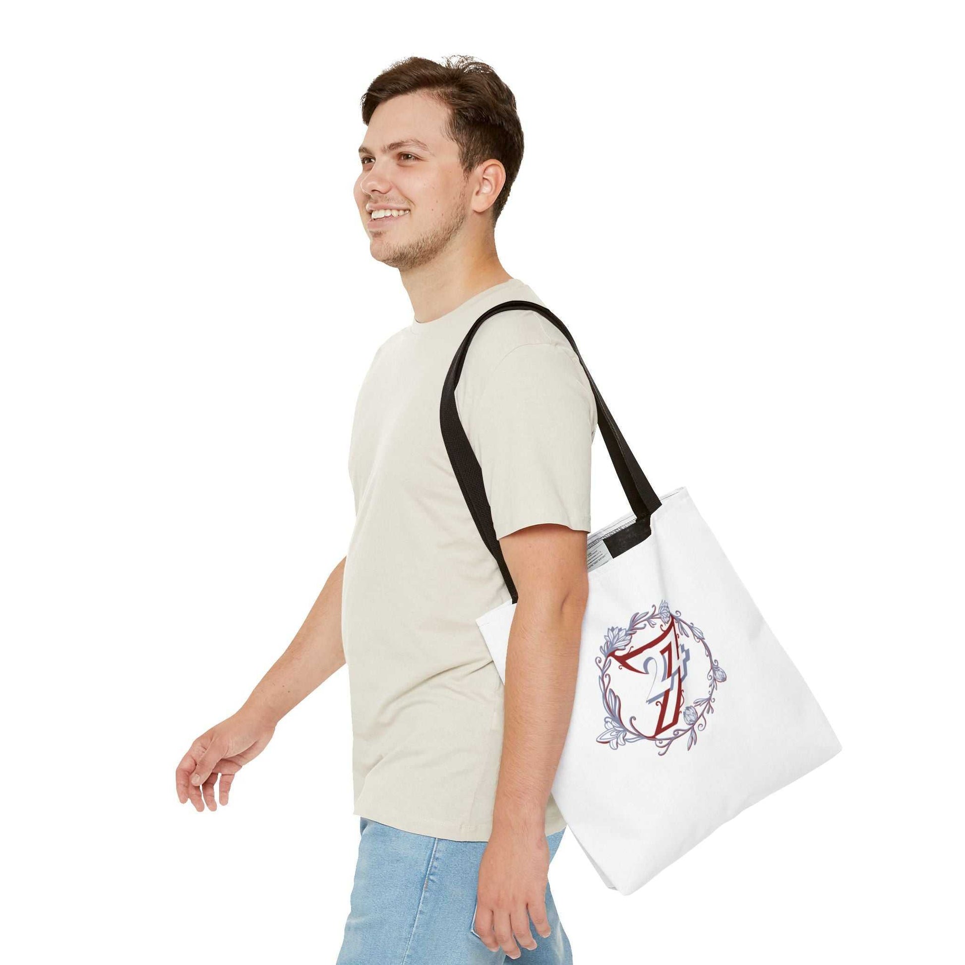 Man carrying a white floral tote bag with a unique design on a white background