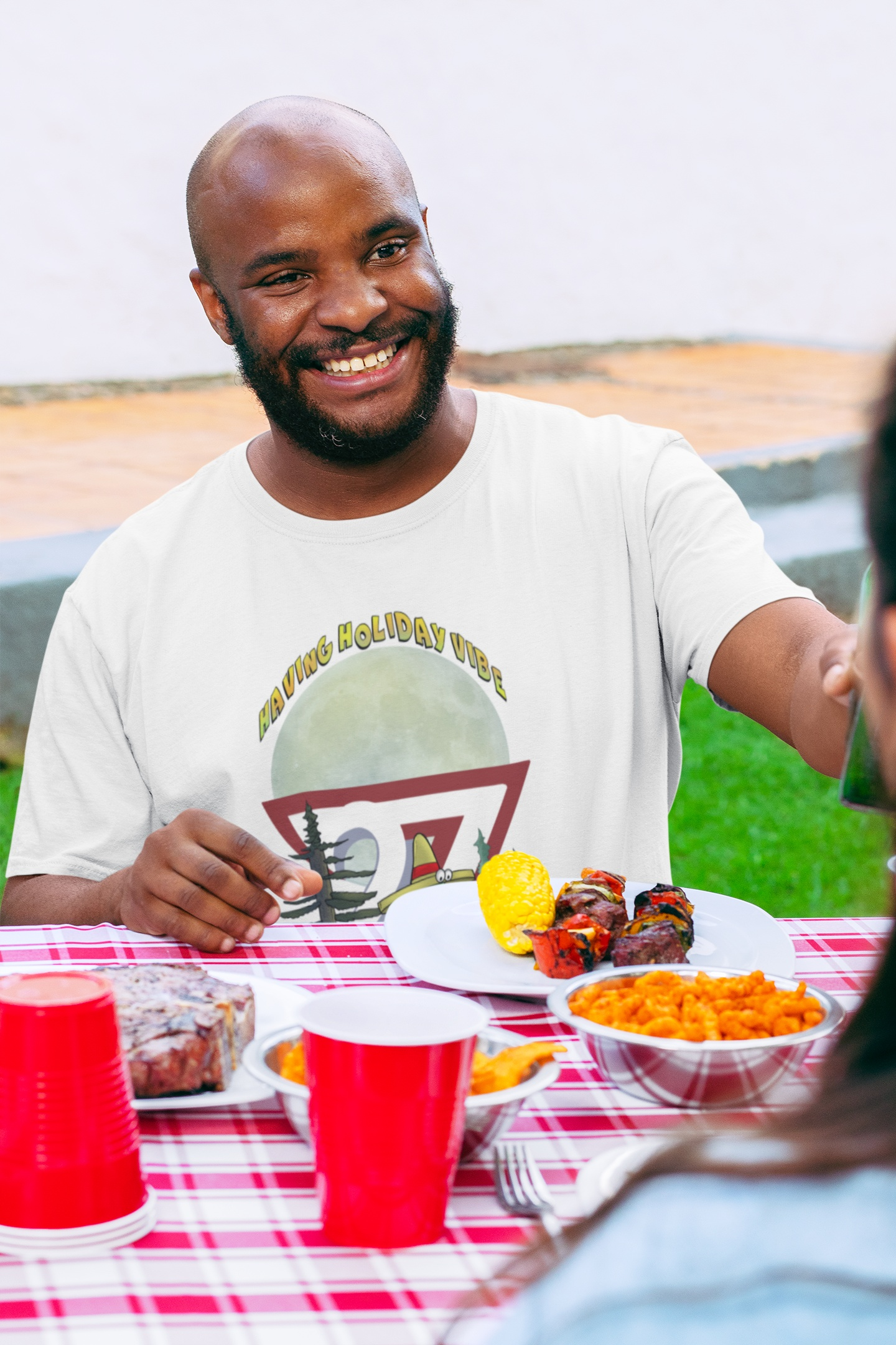 White cartoon BBQ design tee on male model
