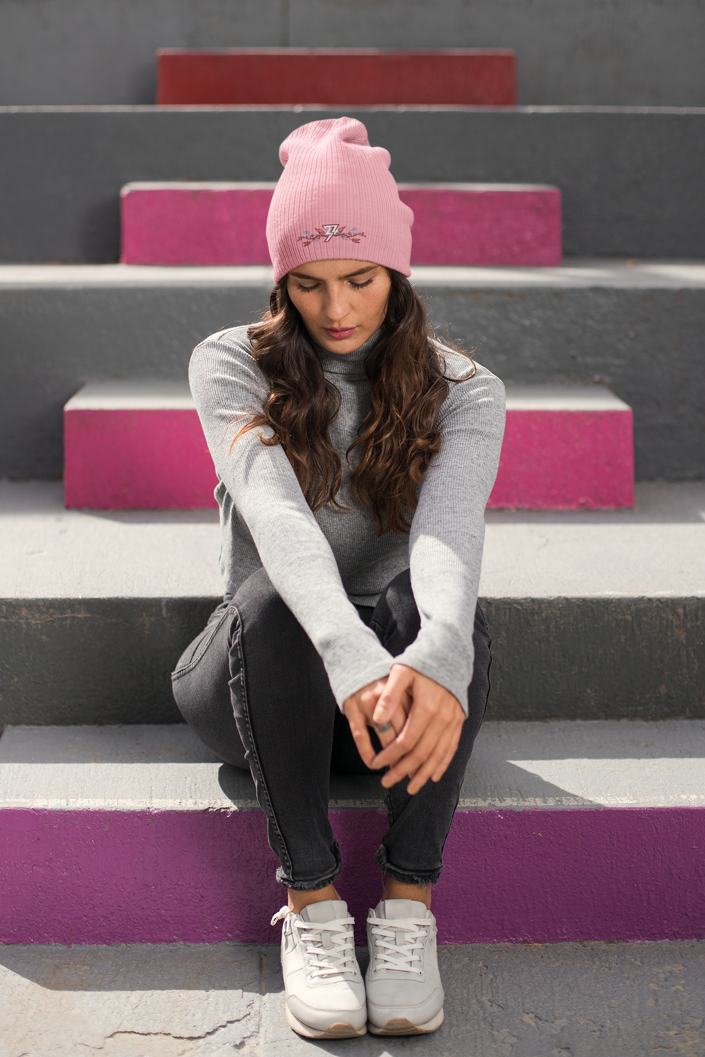 Front view of a female model wearing the baby pink 24/7 Unique Designs floral embroidered beanie.
