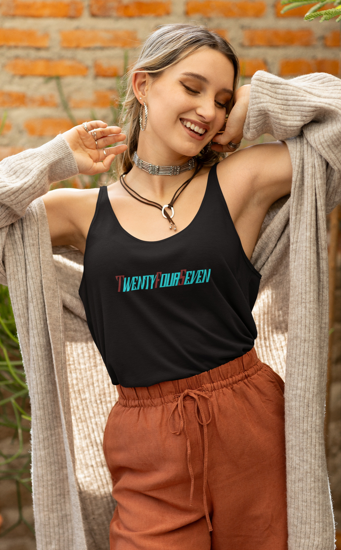 Woman modeling a black premium cotton shirt featuring colorful custom typography.