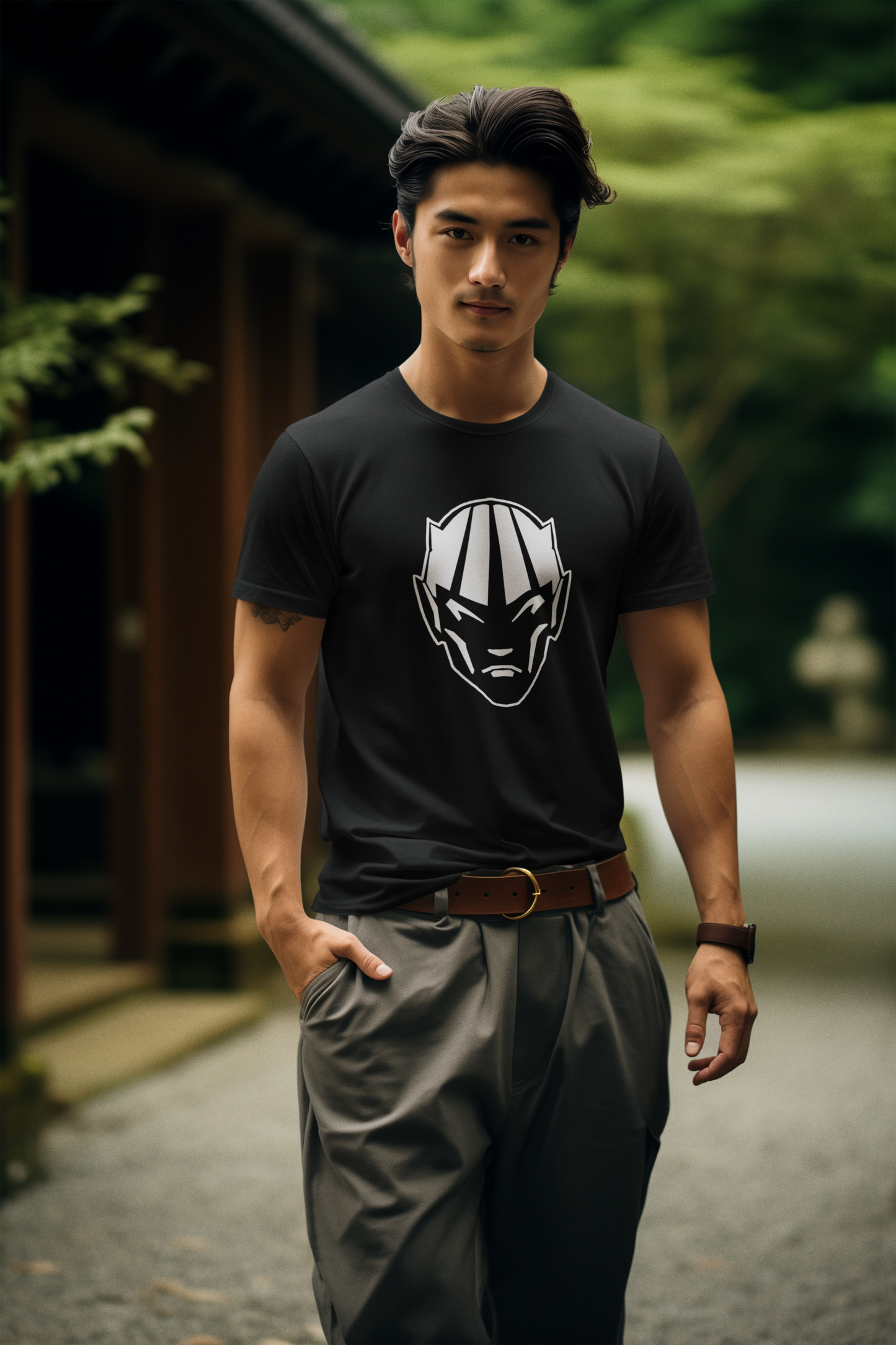 Model styling the black dark fantasy demon face shirt, standing outdoors against a soft green architectural and landscape backdrop.