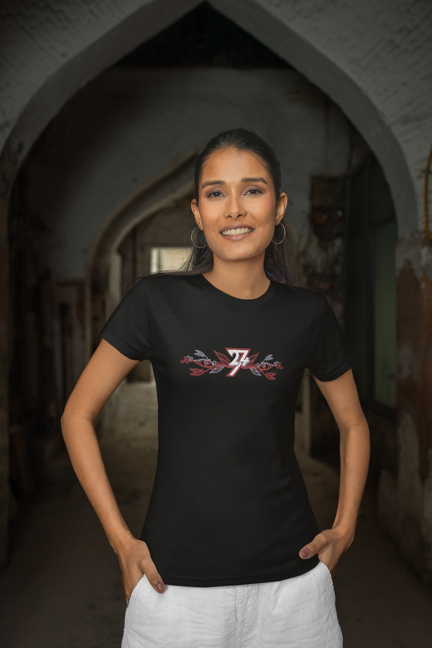 Woman wearing a solid black elegant flower print top from an indie boutique.