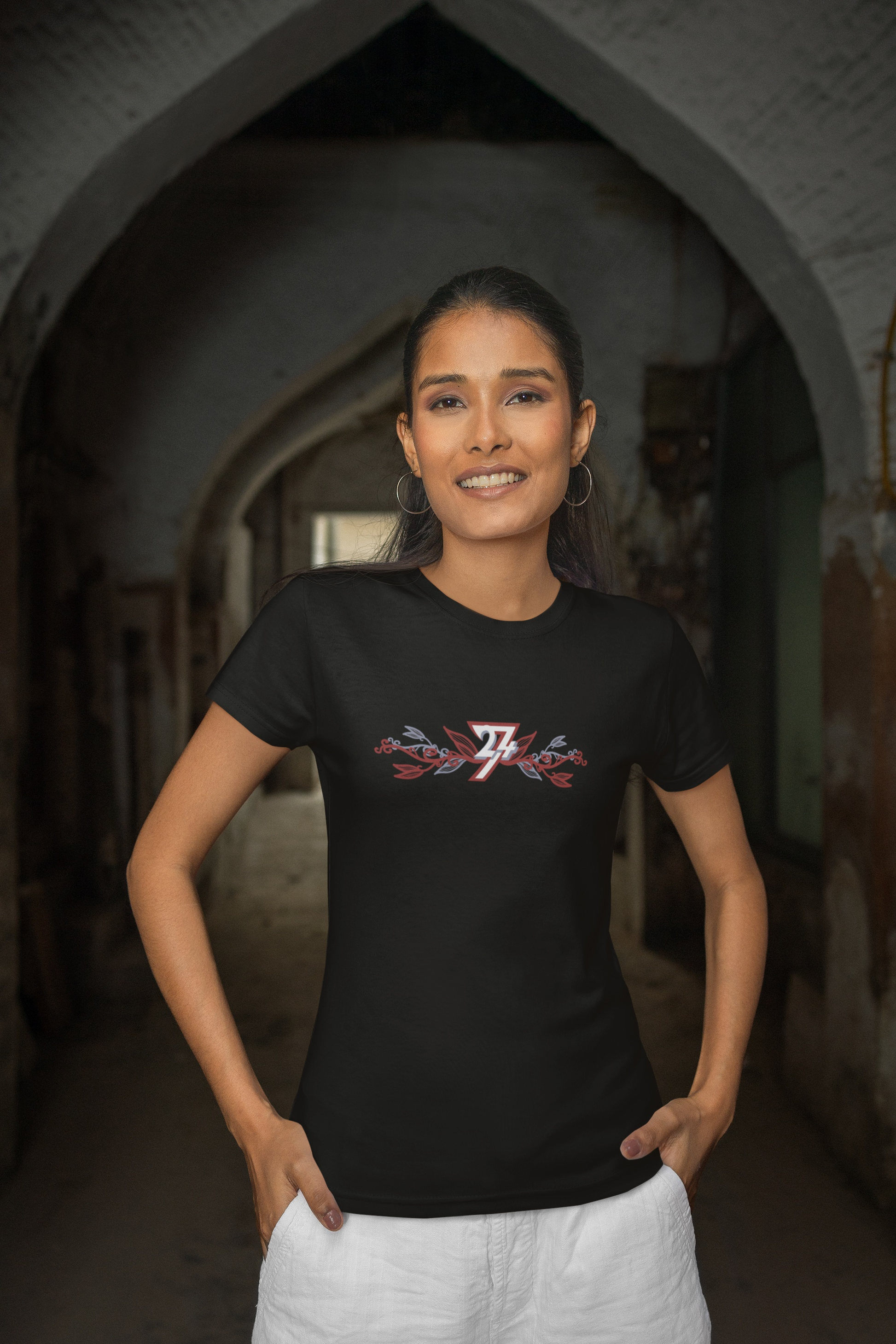 Woman wearing a solid black elegant flower print top from an indie boutique.