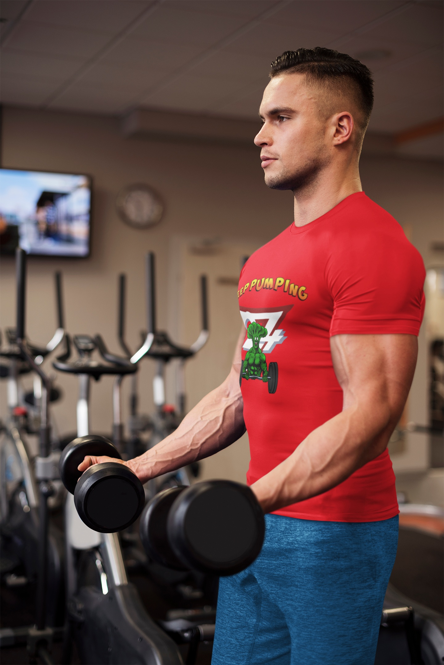 Male model wearing a dark cartoon gym tee, confidently performing a barbell bicep curl in an industrial gym, highlighting the athletic fit of the shirt.