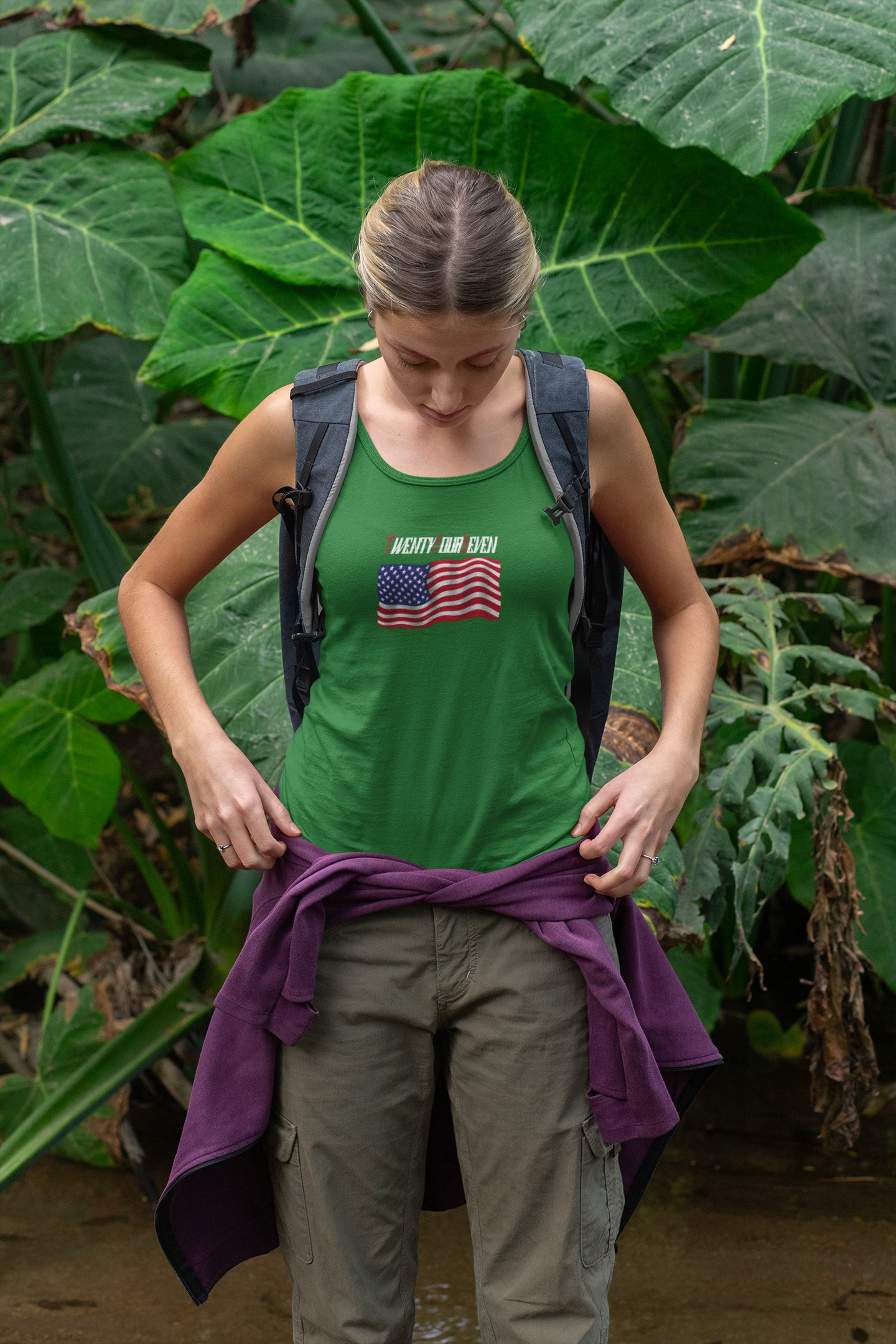 Woman in a vibrant kelly green summer festival tank featuring a custom waving US flag.
