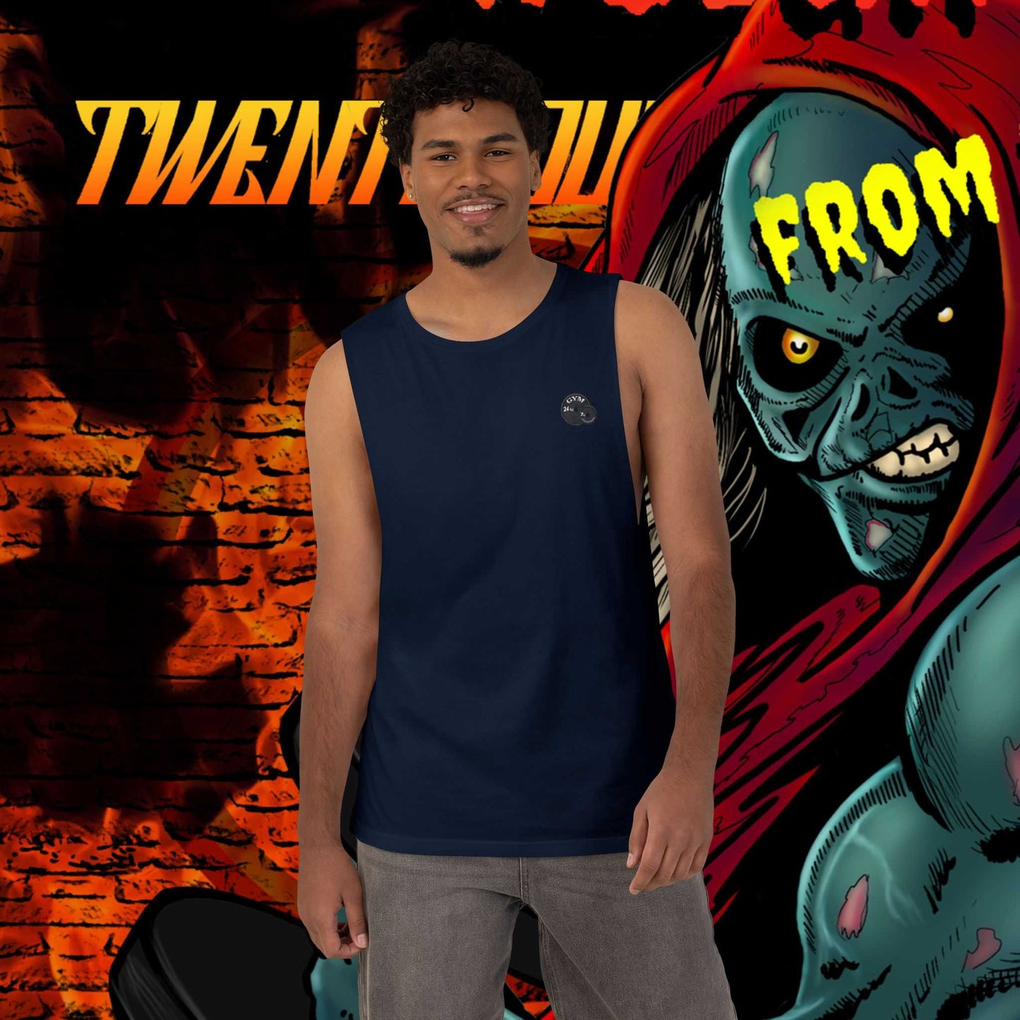 Smiling male model wearing the navy blue horror comic workout shirt, standing in front of a bold, stylized background featuring the Weights From The Crypt ghoul graphic.