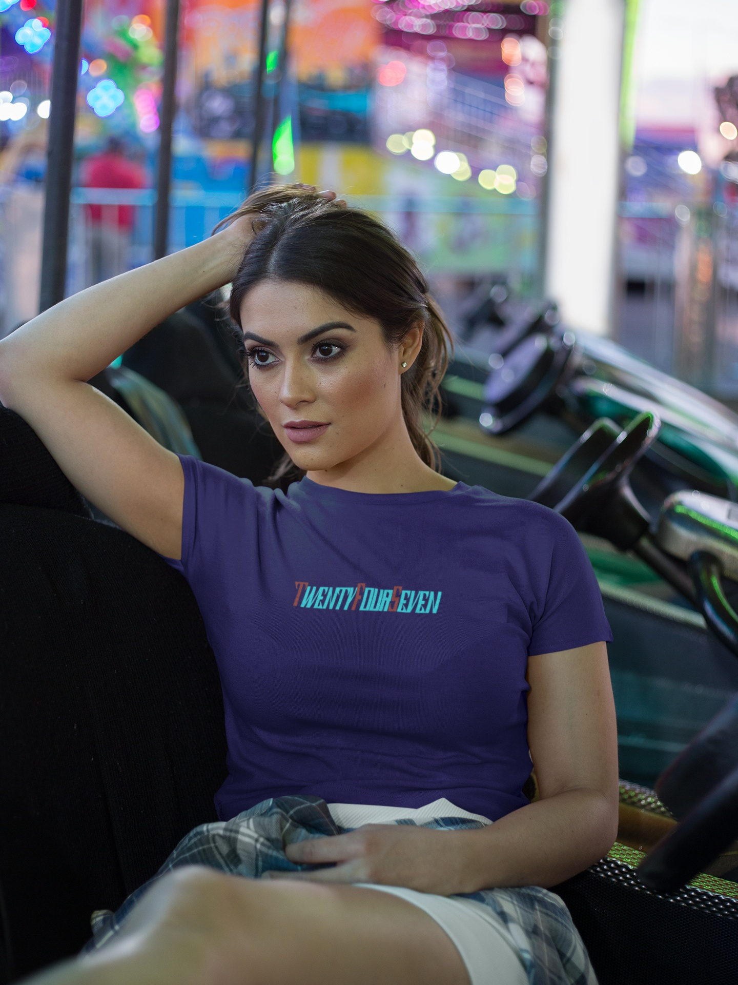 Female model in a purple comfy graphic tee, highlighting the unique TwentyFourSeven artwork.