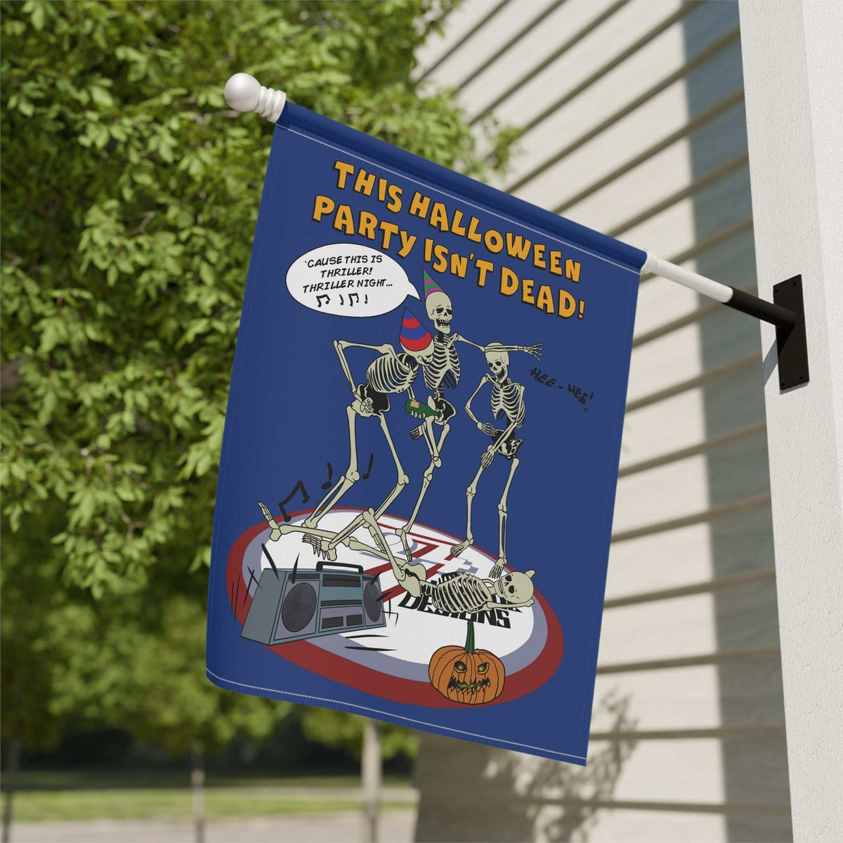 Close-up outdoor view of the double-sided yard flag displaying the digitally hand-drawn dancing skeleton party graphic, mounted securely on a residential siding wall.