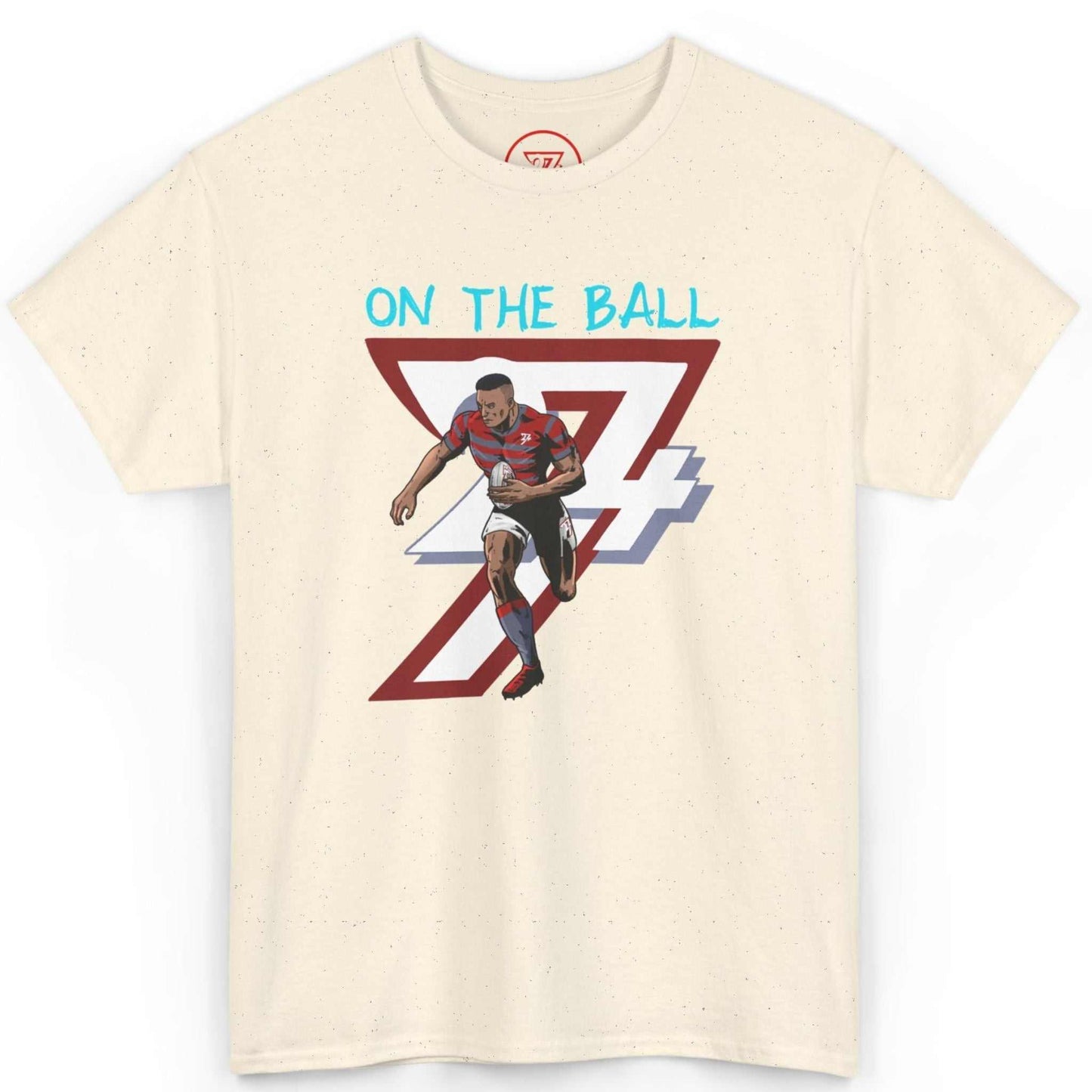 Front view of a natural off-white athletic comic art tee featuring the On The Ball rugby design, laid flat on a clean background.