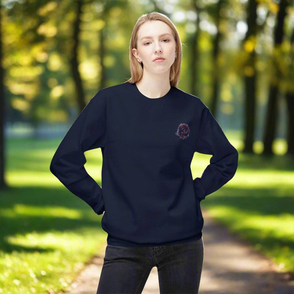 Female model in a navy blue sweater with a classic crew neckline and small flower chest print.