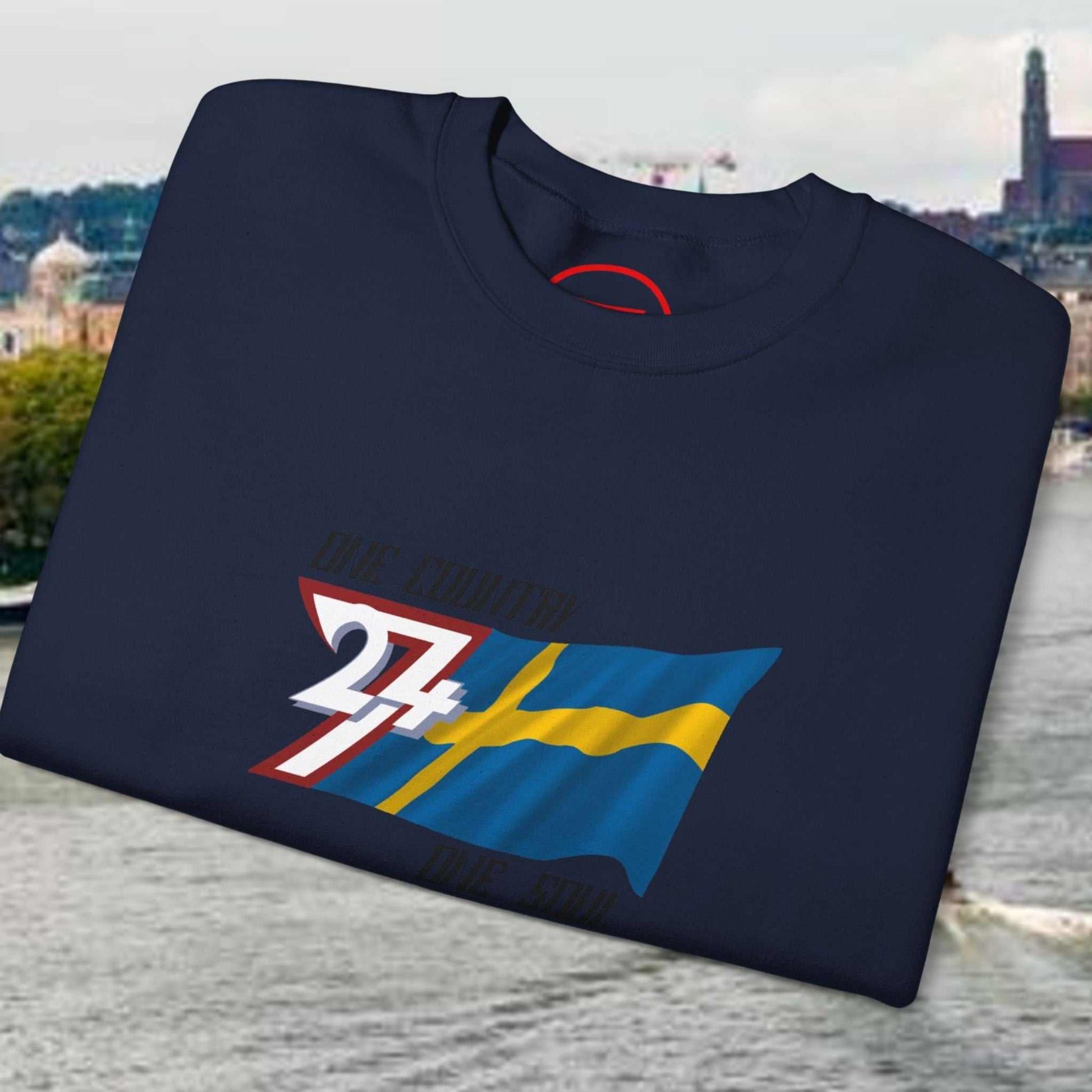 Neatly folded navy Sweden flag pullover showing the cozy inner fleece fabric and the crisp flag print, laid flat.