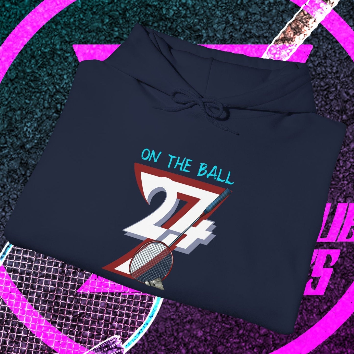 navy blue badminton hoodie sweatshirt with "On The Ball 24/7" graphic design, folded on shuttlecock and racket background