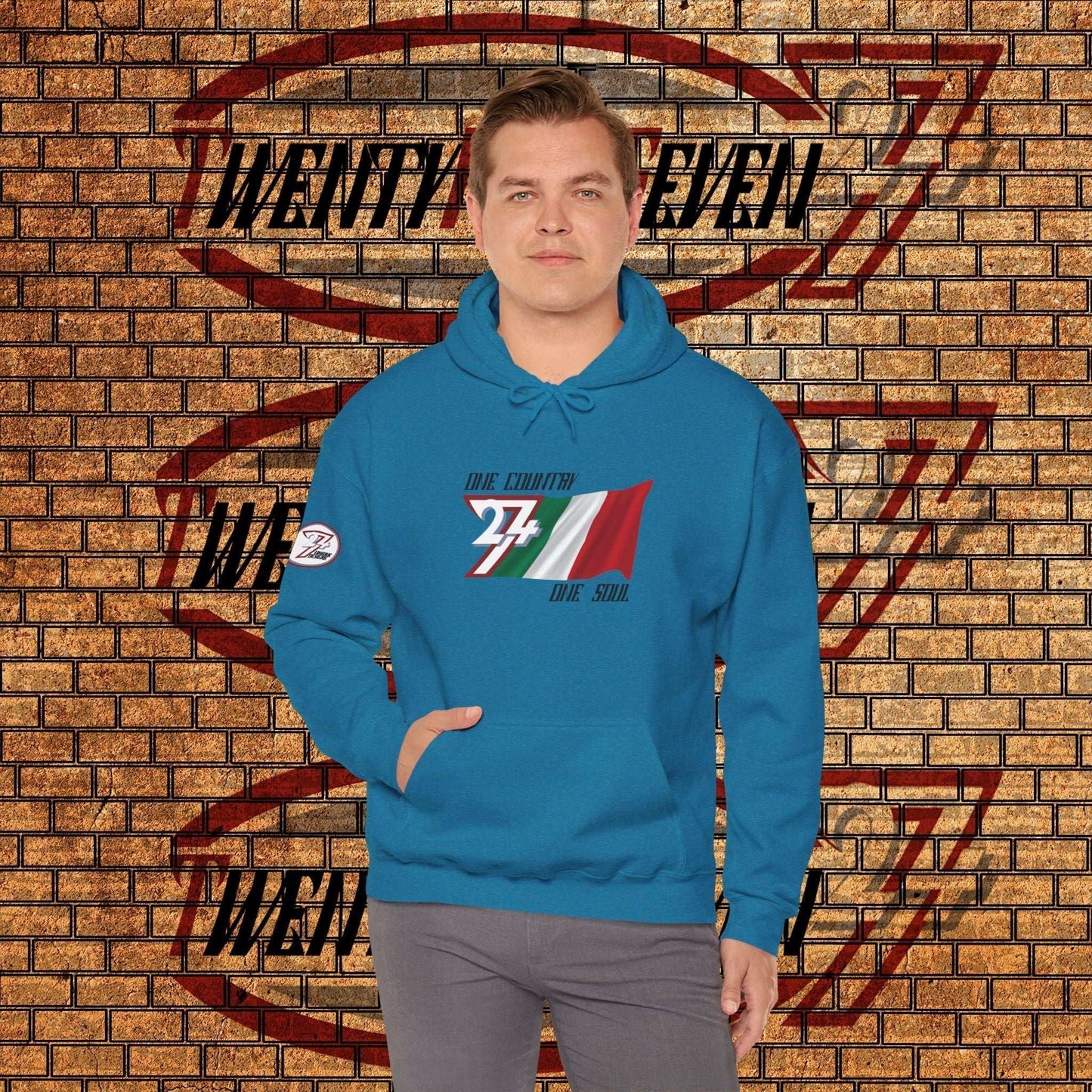 Model wearing the Italia "Heritage" edition hoodie in Ocean Blue, showing a modern, refined Italian streetwear look.
