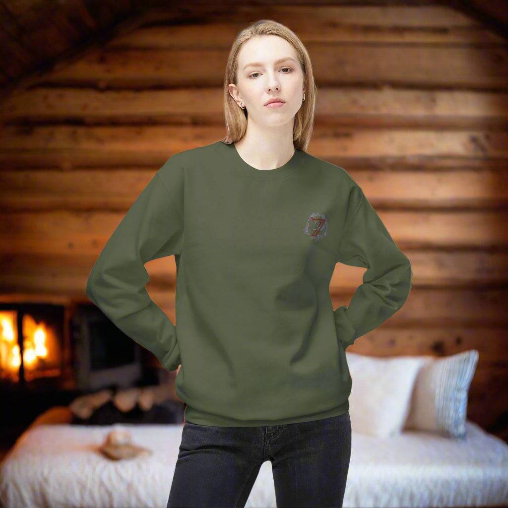 Woman wearing an olive green flower pullover with a small front logo and comfortable everyday drape.