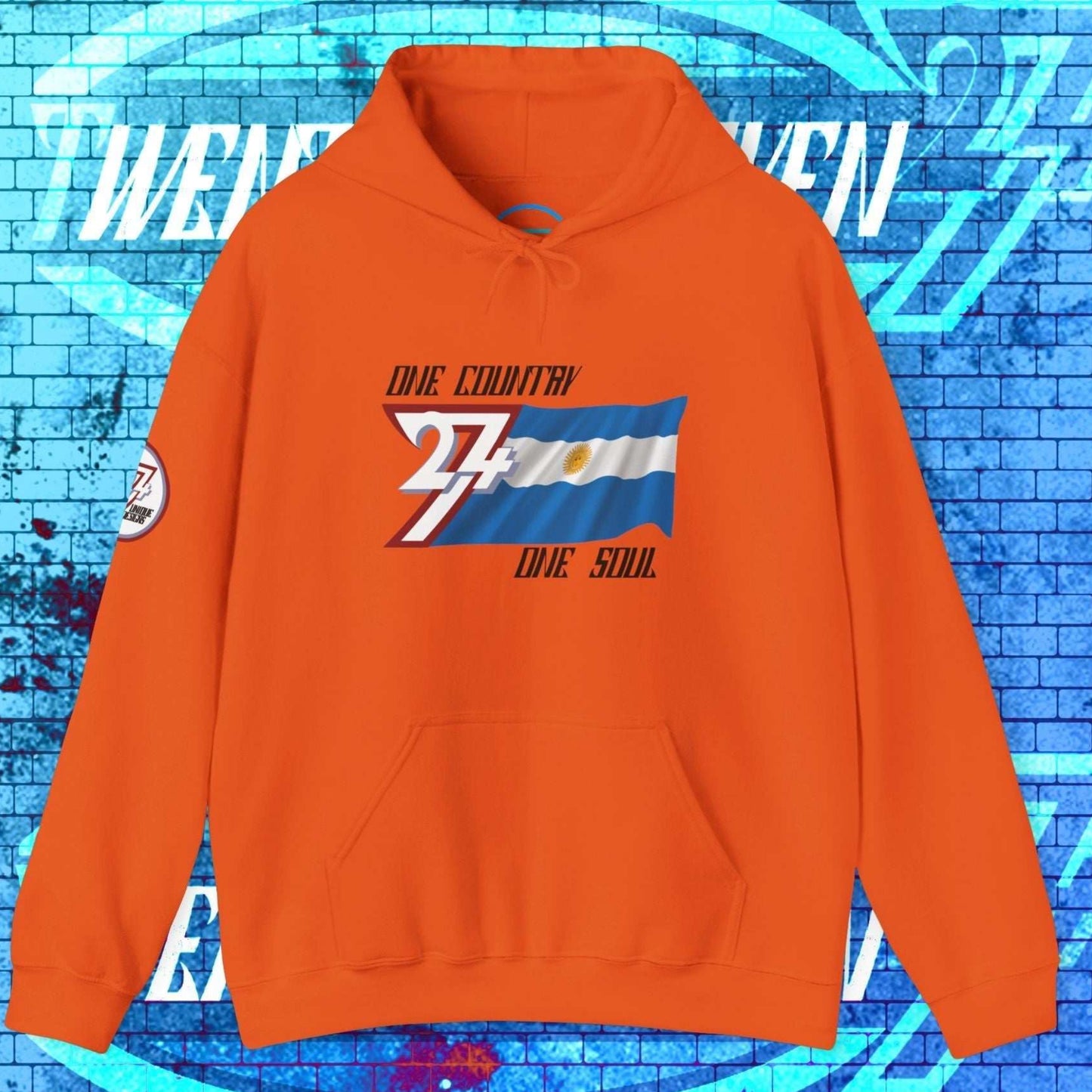 Orange lifestyle hoodie showcasing 24/7 passion for Argentina with refined "Atelier" art.