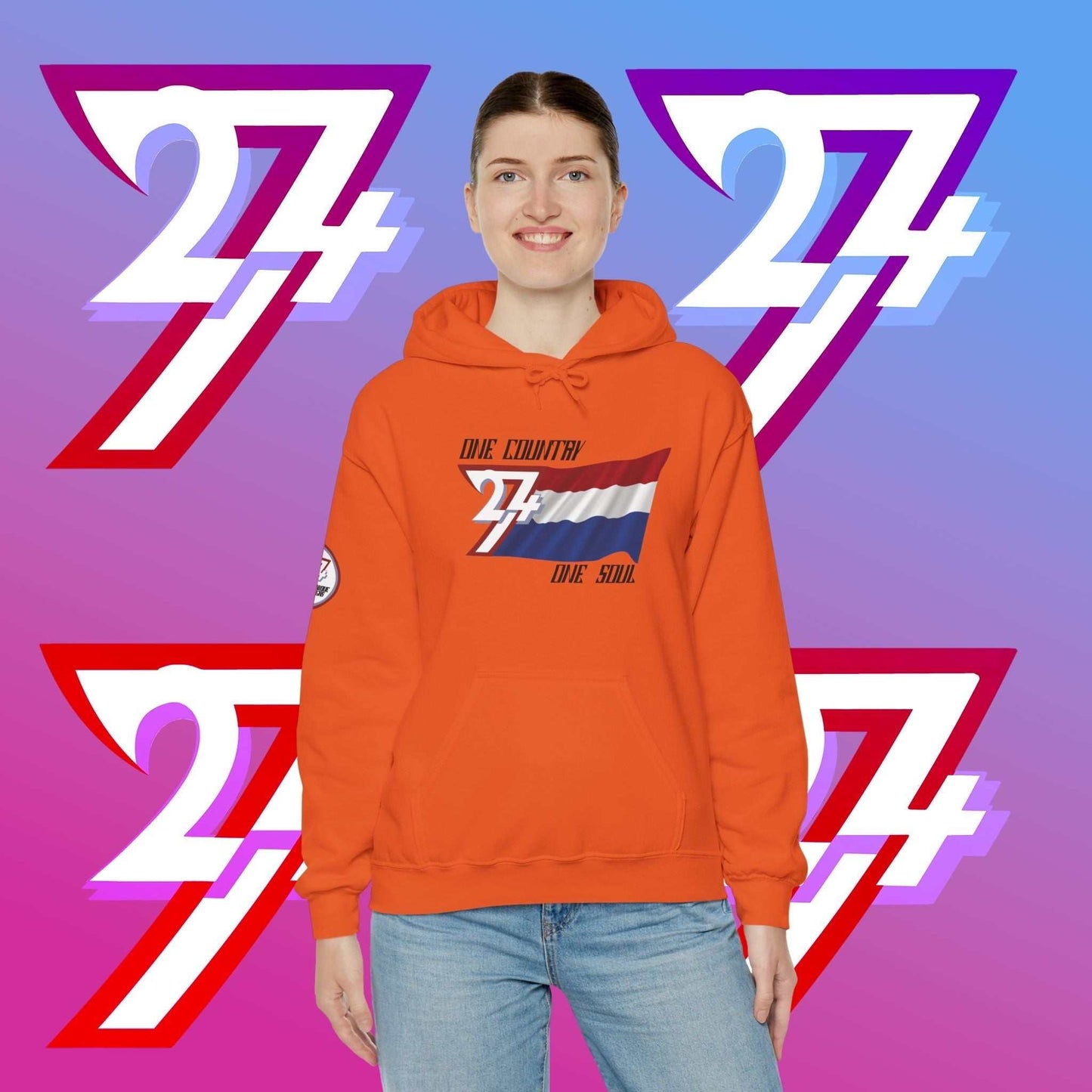 Female model wearing the Nederland "Oranje" edition hoodie in Orange, showing a modern, refined Dutch streetwear look.
