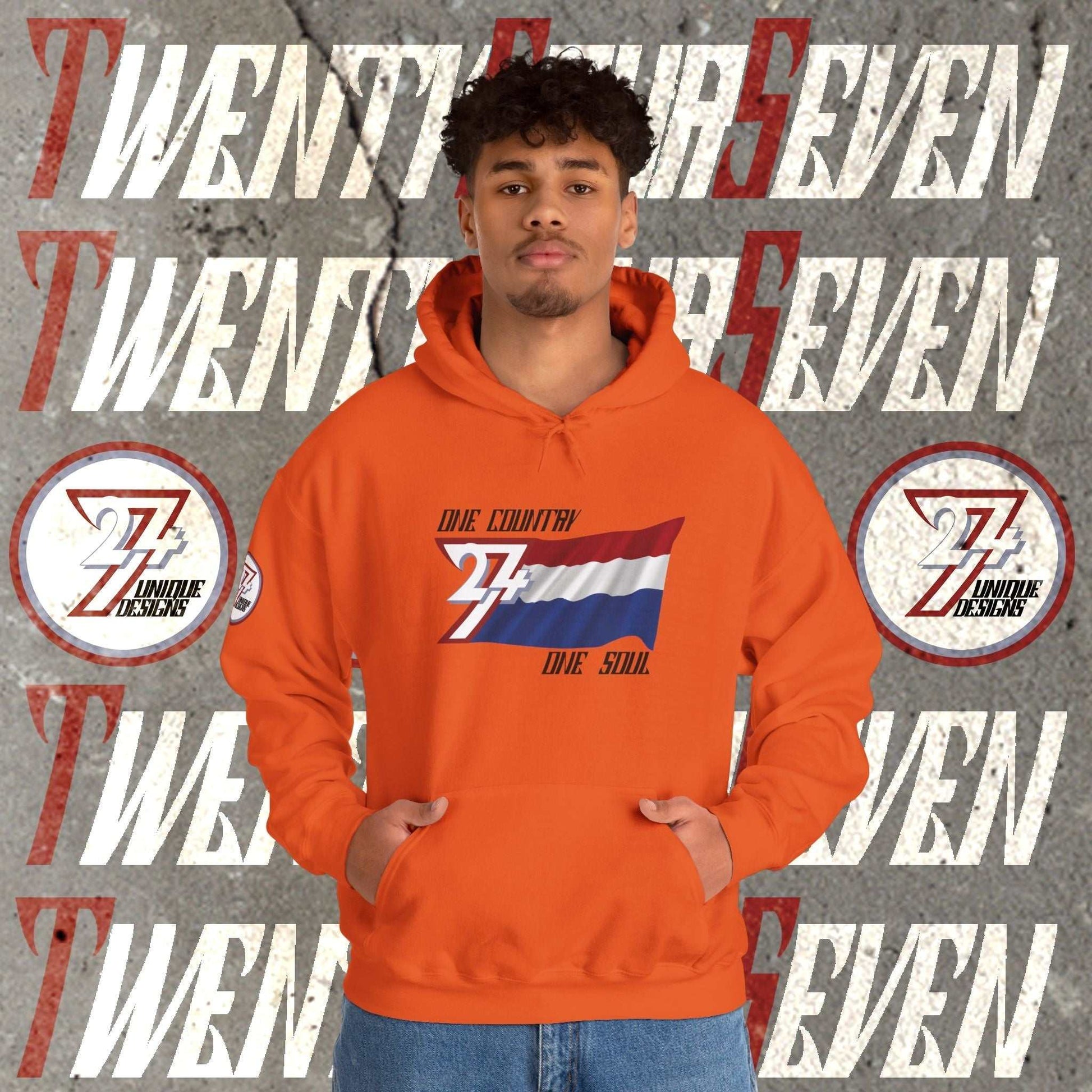 Male model wearing the Nederland "Oranje" edition hoodie in Orange, showing a modern, refined Dutch streetwear look.