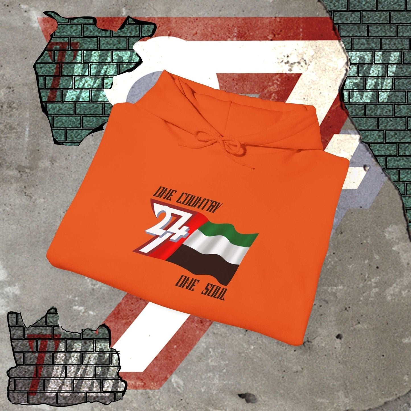 A professional display of the UAE flag hoodie in Orange, folded to showcase the refined hand-drawn graphic and high-quality fleece finish.
