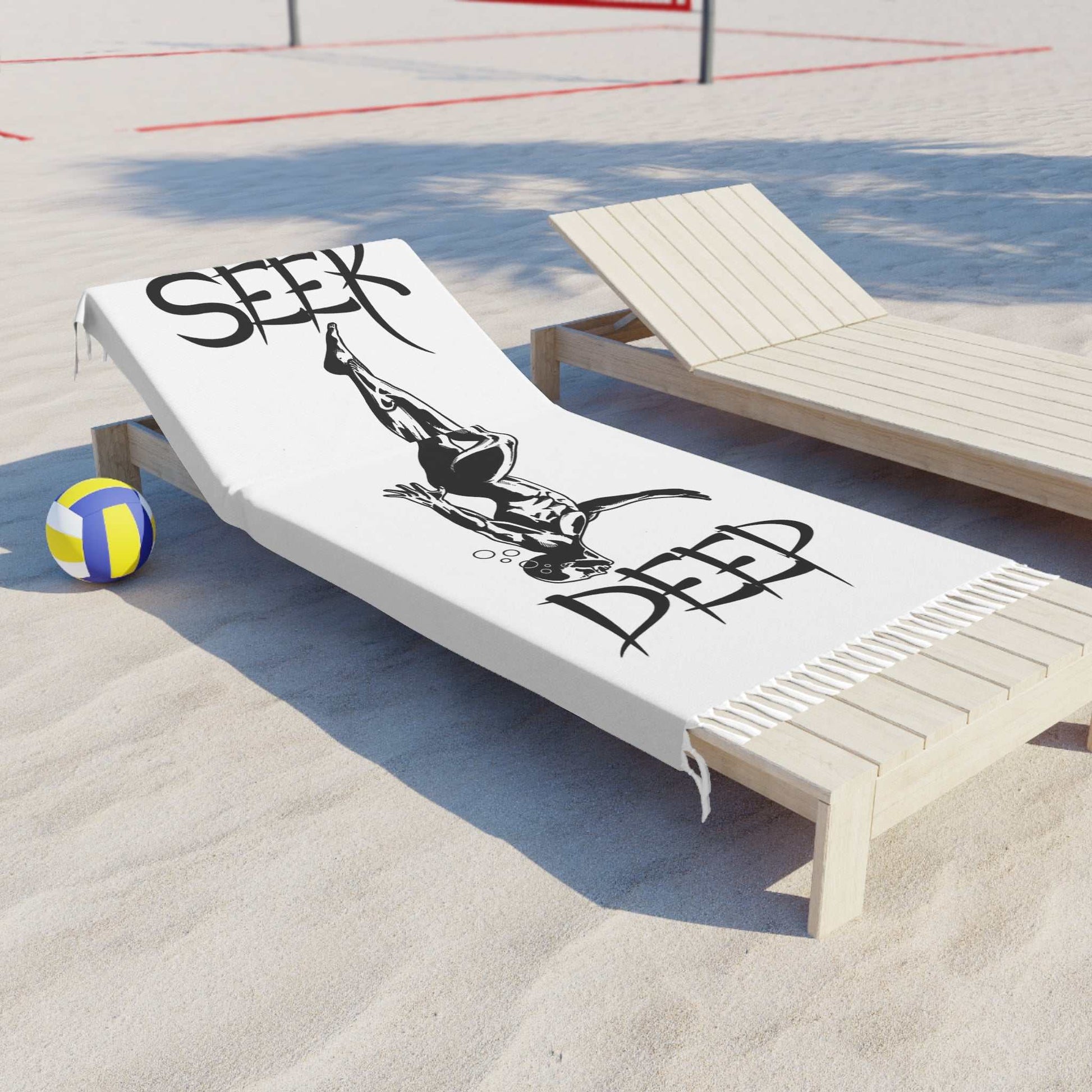 Oversized black and white beach towel with fringe edges displaying a diver graphic and the words SEEK DEEP.