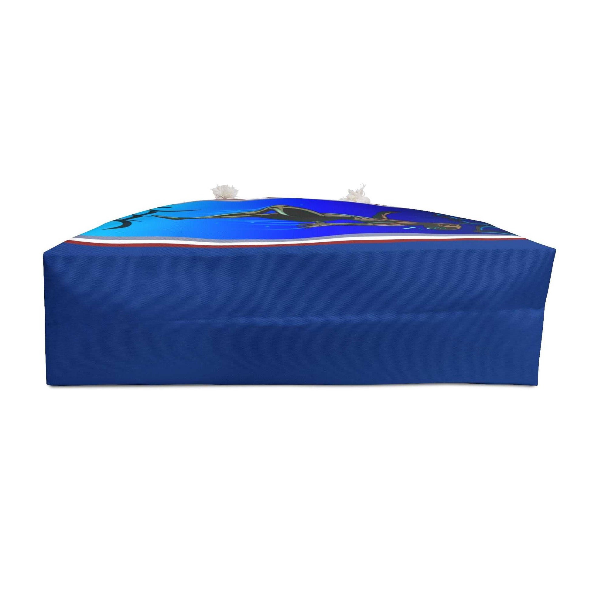 Bottom view of the oversized travel tote, showcasing the wide, flat blue base designed to provide stability and maximum packing capacity for beach trips.