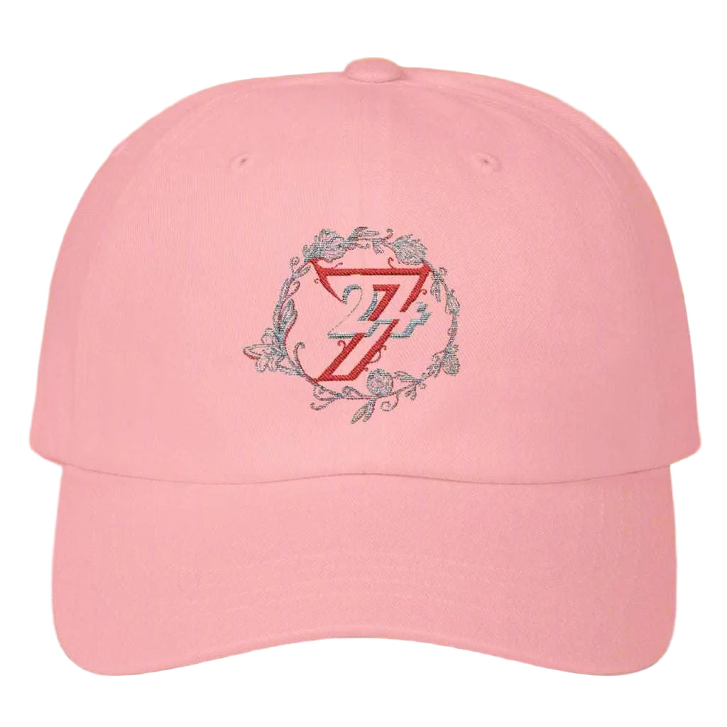 Flat lay view of a pink trendy floral wreath hat showcasing the exclusive brand logo.