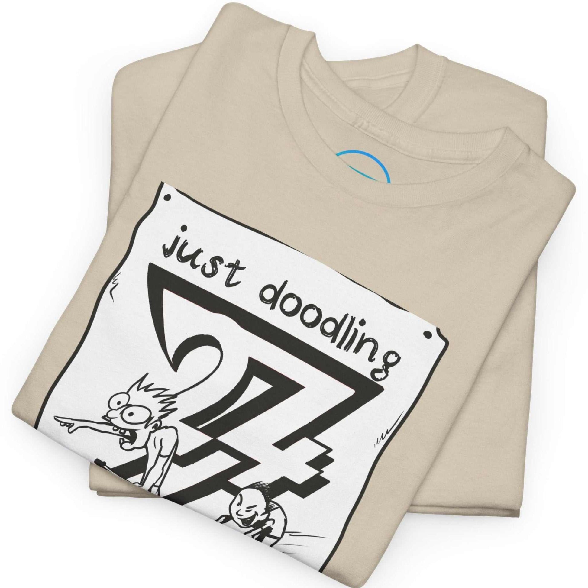 Neatly folded sand beige doodle art graphic tee showing the premium ethical cotton fabric and the crisp sketch print, laid flat.