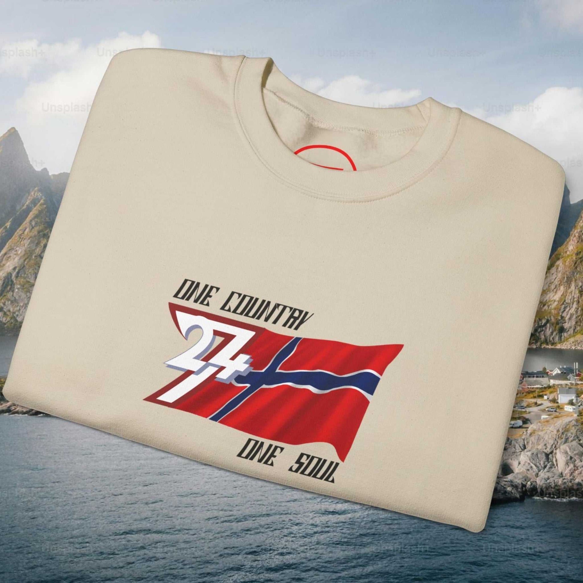 Neatly folded sand beige Norwegian flag pullover showing the cozy inner fleece fabric and the crisp flag print, laid flat.