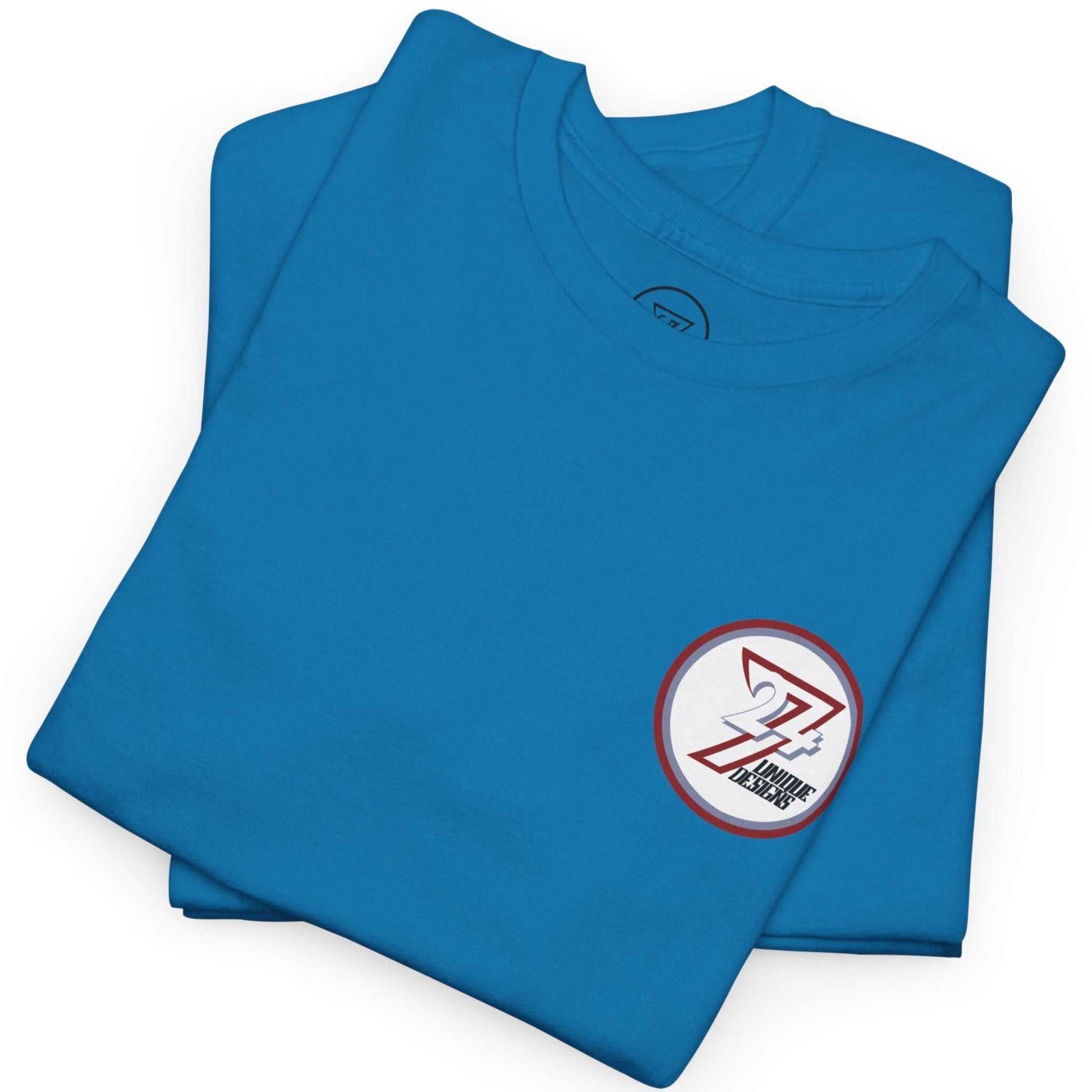 Neatly folded bright sapphire indie comic book shirt showing the premium cotton fabric and the colorful back print, laid flat.