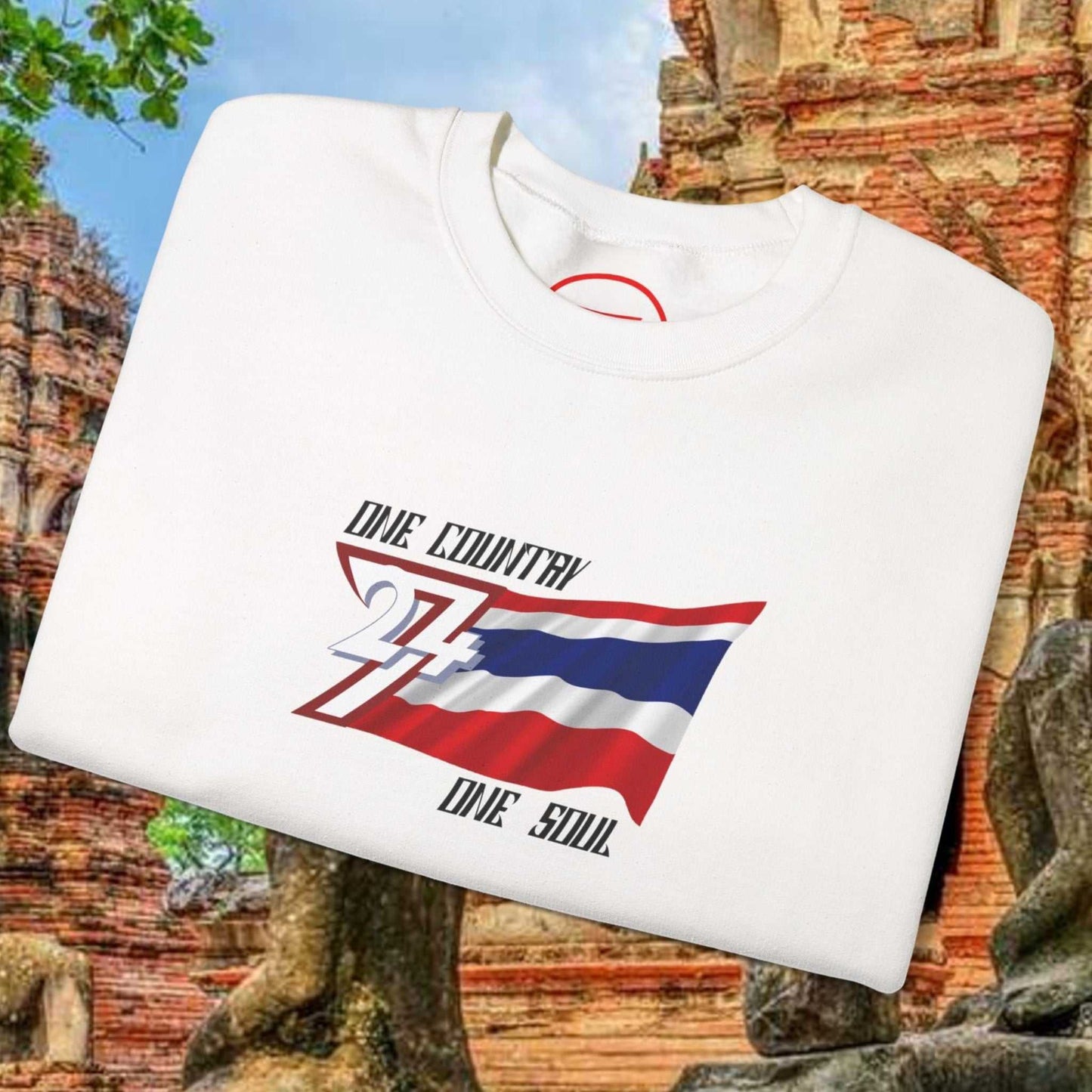 White Thailand flag sweatshirt with "One Country One Soul" text and Thai flag graphic, laid on ancient temple background