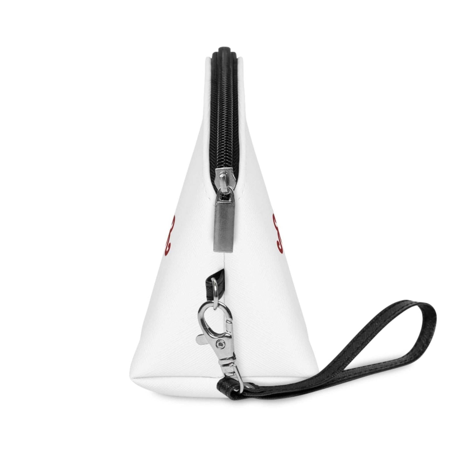 Left side profile of the travel beauty case, highlighting the structured triangular gusset, the silver zipper hardware, and the detachable black wristlet strap.