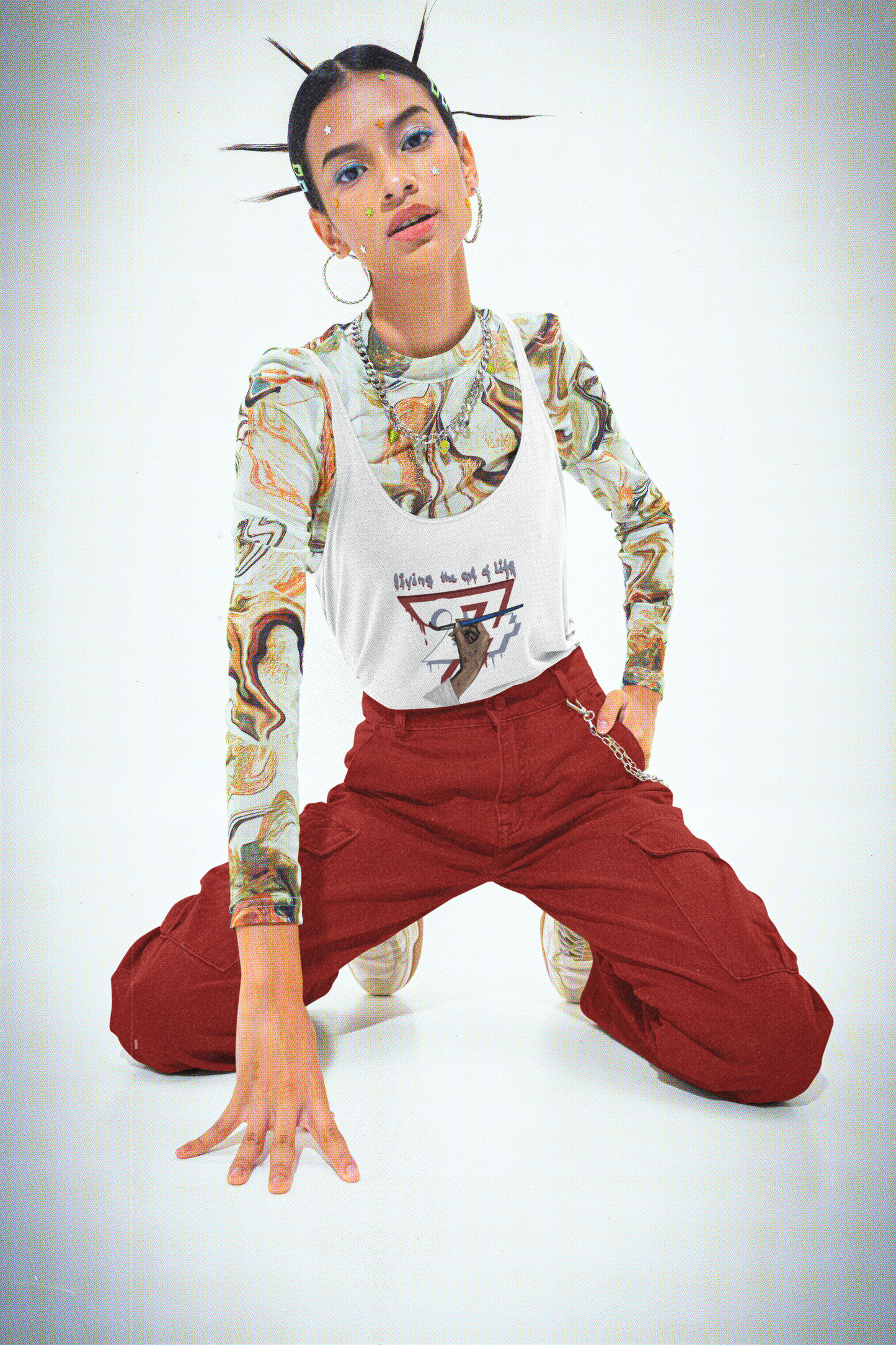 White women's jersey tank top featuring an illustration of a hand holding a paintbrush with the text Living the Art of Life on female model.