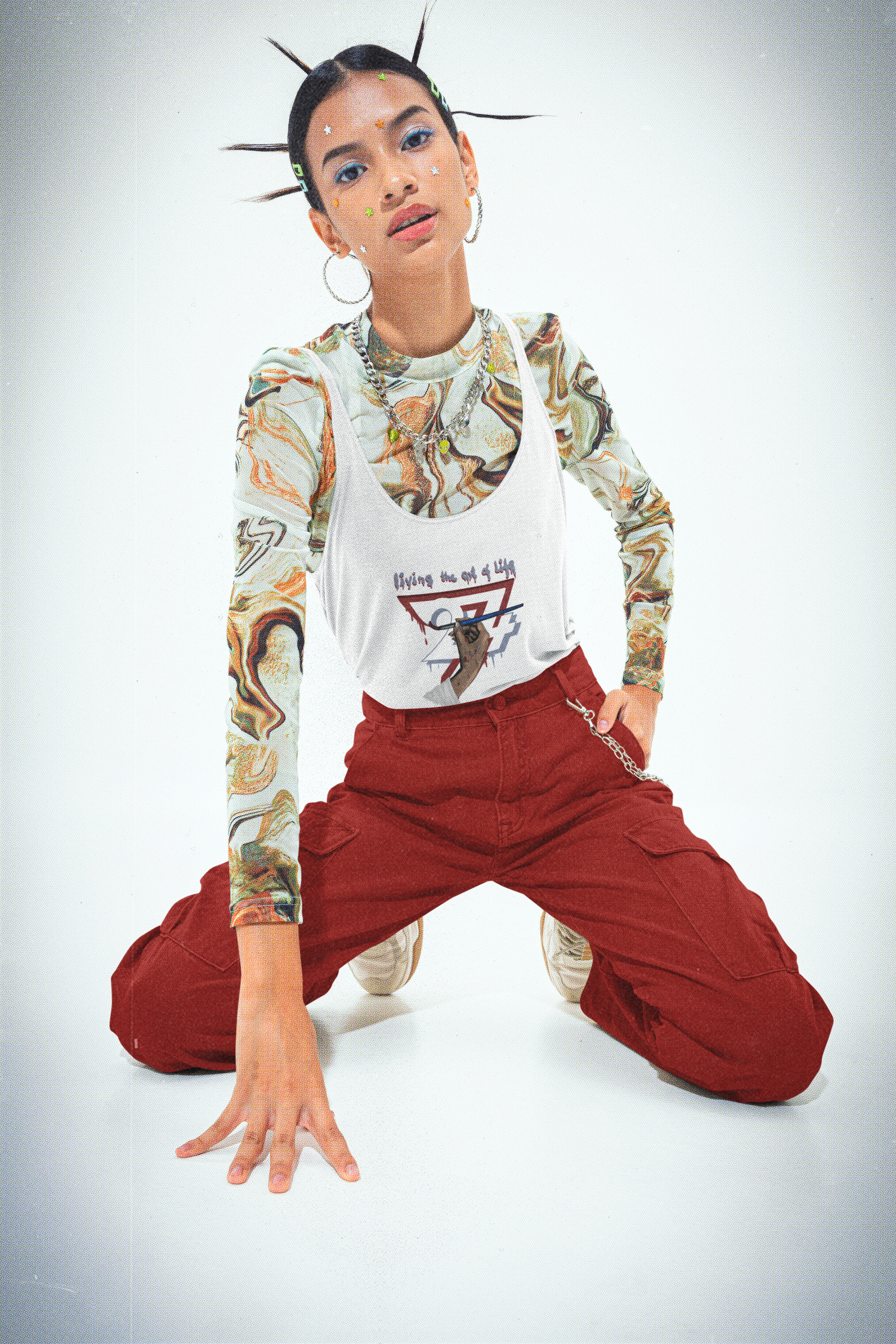 White women's jersey tank top featuring an illustration of a hand holding a paintbrush with the text Living the Art of Life on female model.