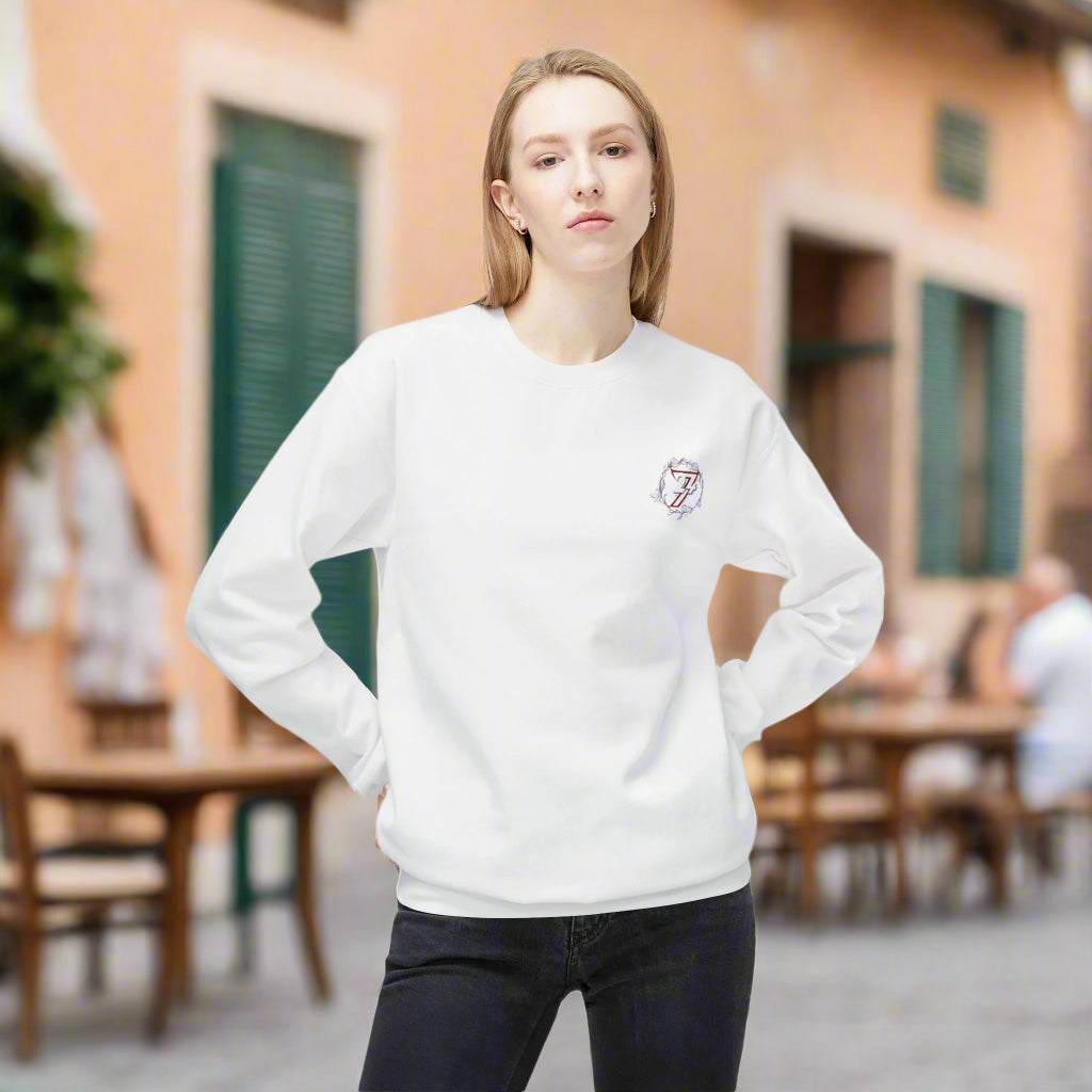 Woman modeling a white flower graphic sweatshirt showing a small floral chest logo and slouchy fit.