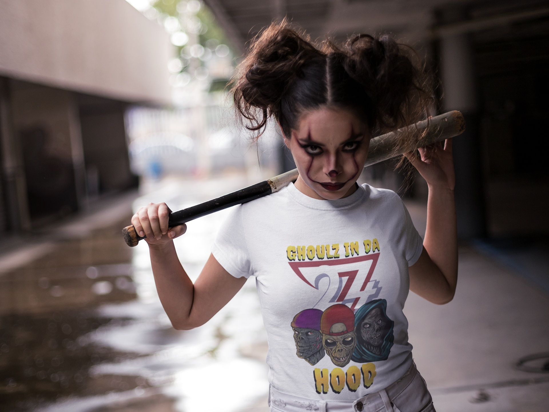 Front view of the white Ghoulz in da Hood t-shirt worn by a female model