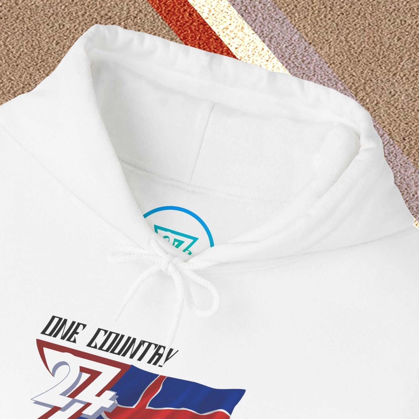 Macro close-up of the inner neck area showing the tear-away label and authentic 24/7 Unique Designs trademark logo.