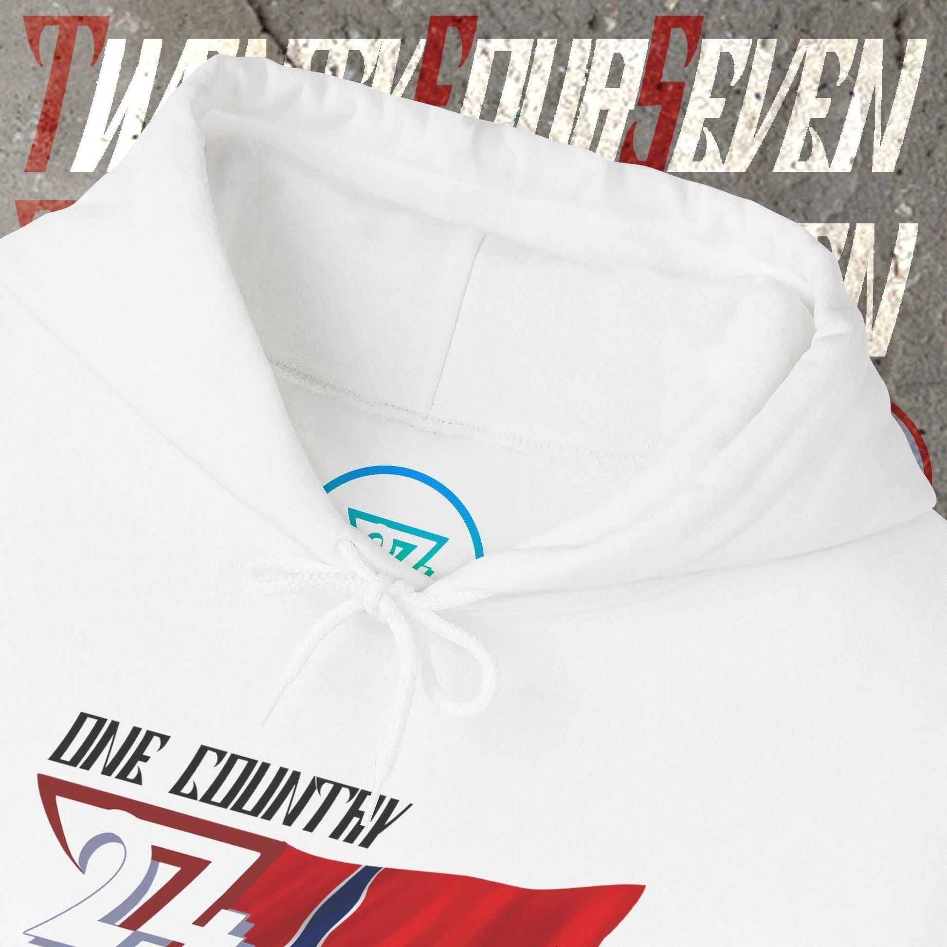 Macro close-up of the inner neck area showing the tear-away label and authentic 24/7 Unique Designs trademark logo.