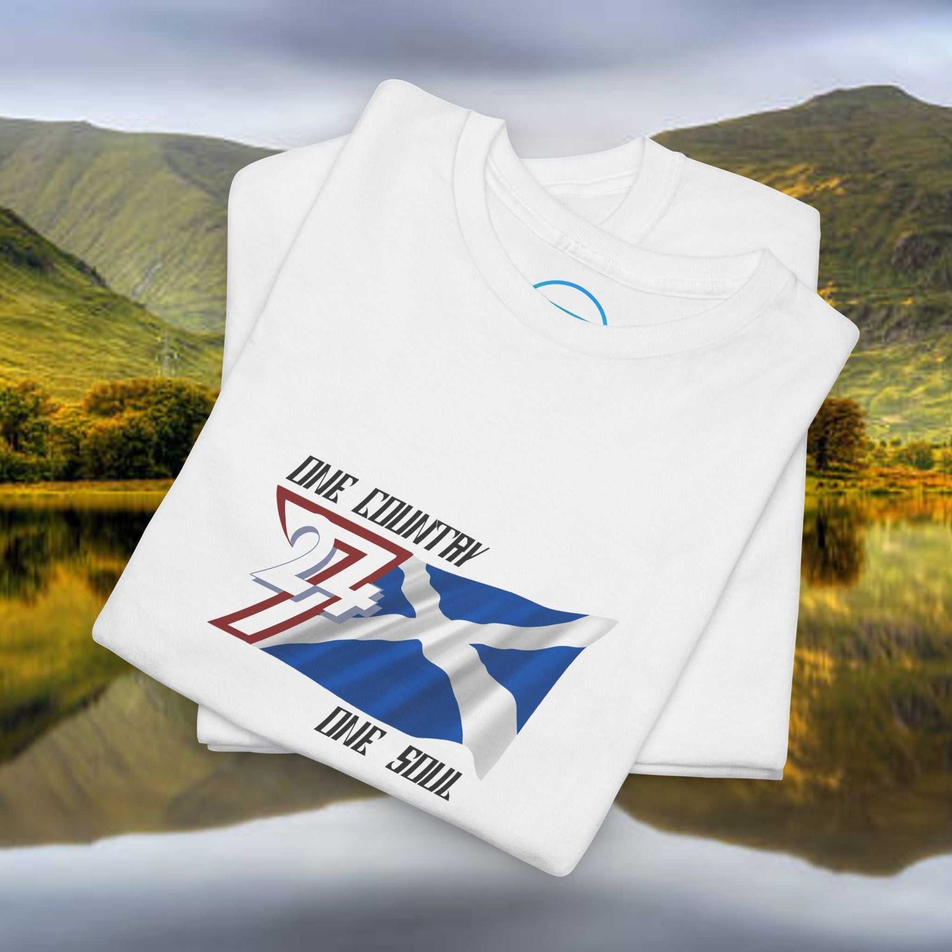 Folded white Scotland Graphic Tee with hand-drawn Saltire design on unisex cotton shirt