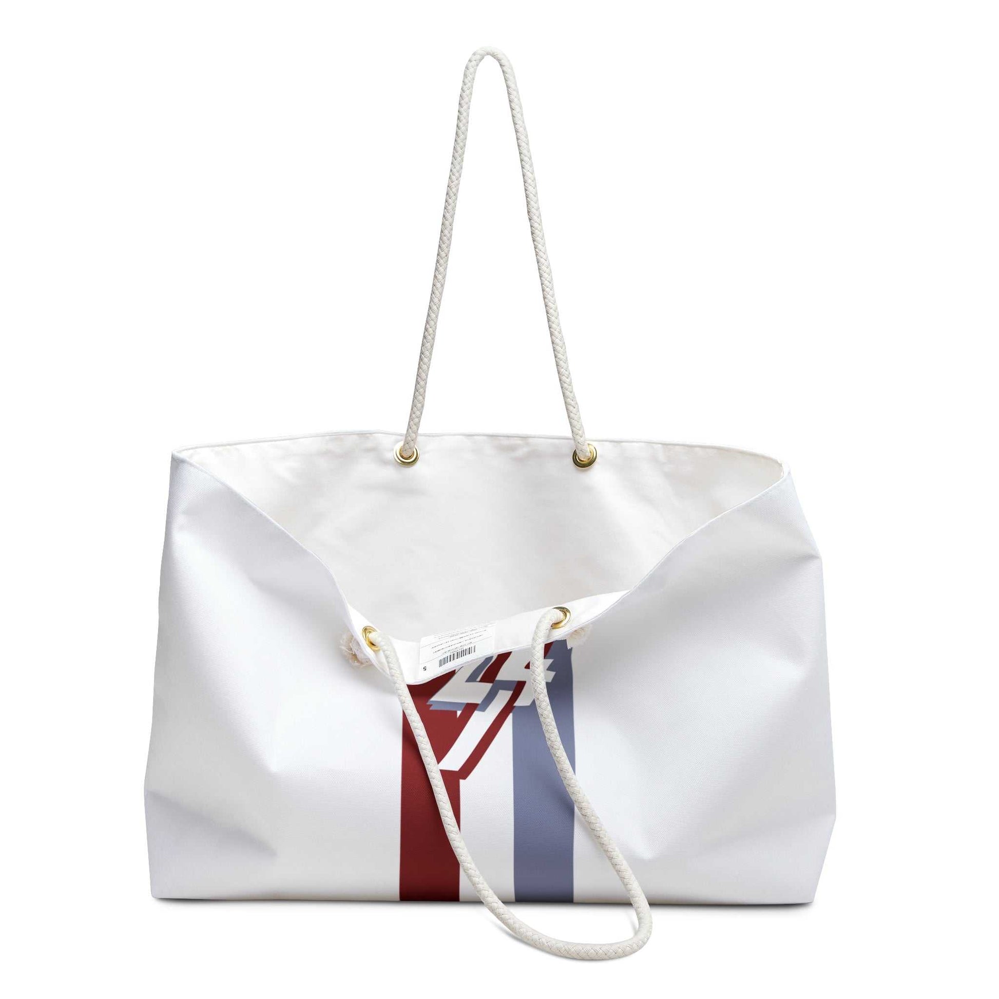 Angled view of the white weekender bag slightly open on the right side, revealing a glimpse of the premium interior lining and the sturdy metal handle grommets.