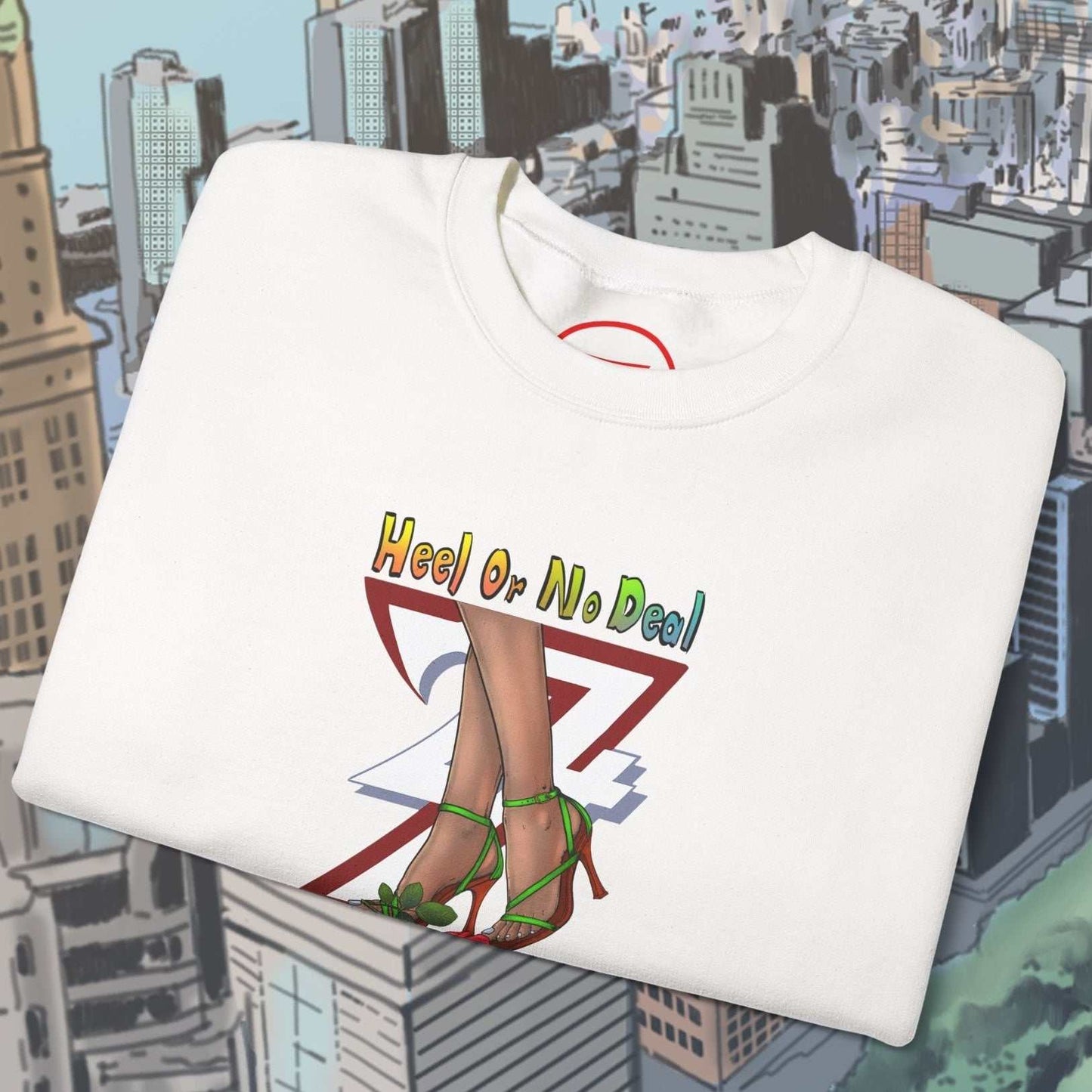 white sweatshirt with hand-drawn rose design and colorful text "Heel Or No Deal" folded on cityscape background