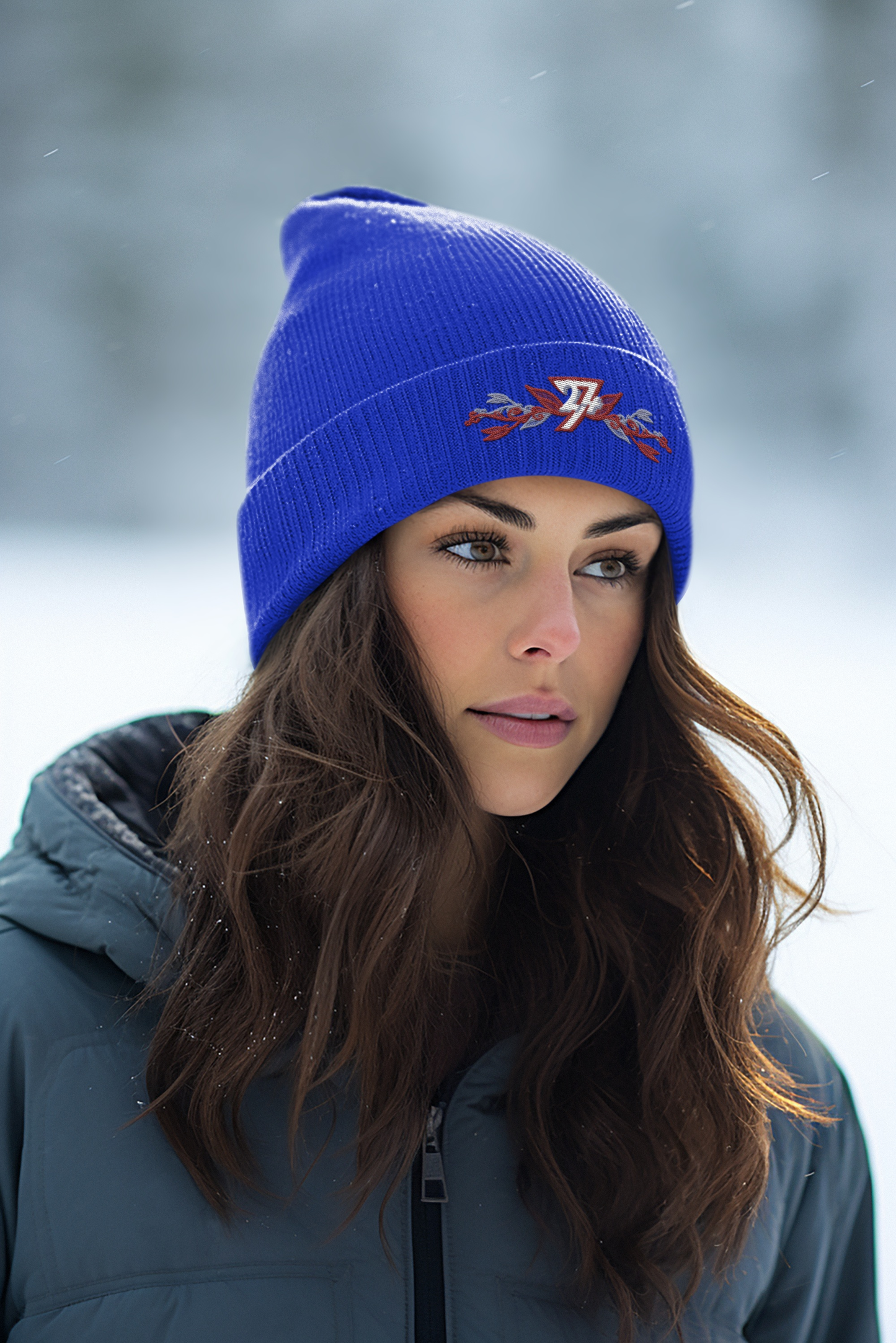 Front view of a female model wearing the bright royal blue 24/7 Unique Designs floral embroidered beanie.