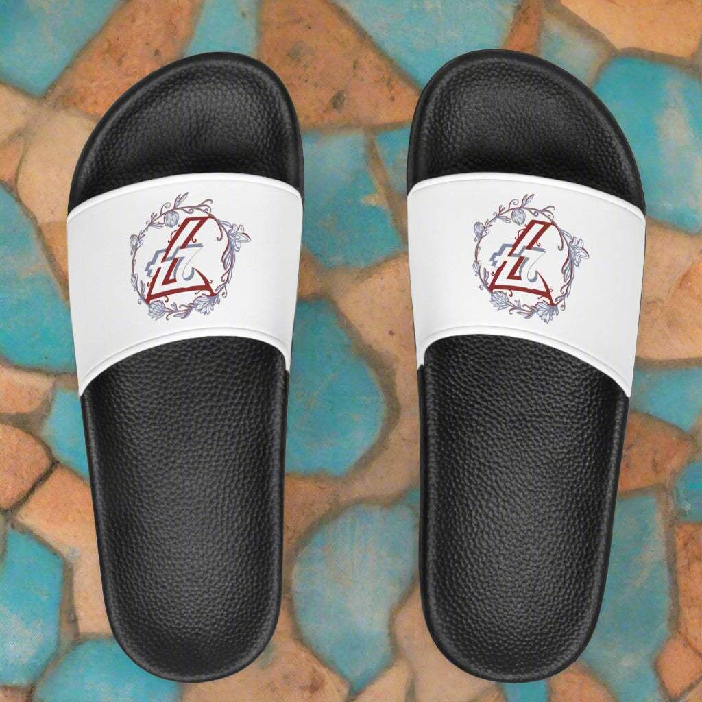 Top-down view of women's floral slide sandals featuring an elegant blue and burgundy logo design.